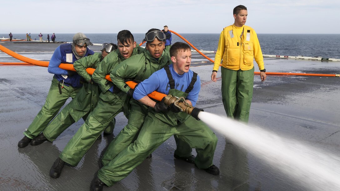 Sailors practice handling a fire hose during a flight deck scrubbing evolution on the Pre-Commissioning Unit Gerald R. Ford in the Atlantic Ocean, April 13, 2017. The future USS Gerald R. Ford is underway on its own power for the first time and will conduct  builder's sea trials to test many of the ship's key systems and technologies. Navy photo by Petty Officer 1st Class Joshua Sheppard