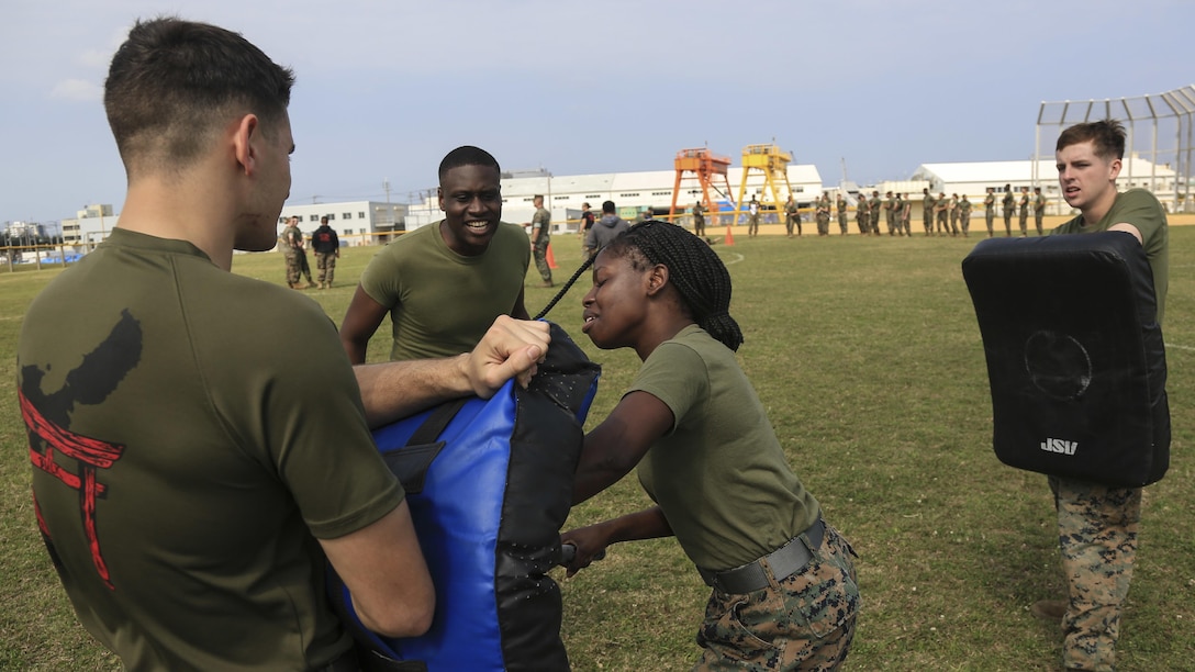 U.S. Marine Corps Lance Cpl. Jesula Jeanlouis, combat photographer, assigned temporary additional duty to Provost Marshal’s Office, Marine Corps Base Camp Butler, participates in Oleoresin Capsaicin spray as part of a Security Augmentation Force qualification event at Camp Kinser, Okinawa, Japan, April 14, 2017. The SAF Marines are required to receive level one OC contamination in order to know how to properly function and provide security while being affected by the spray.