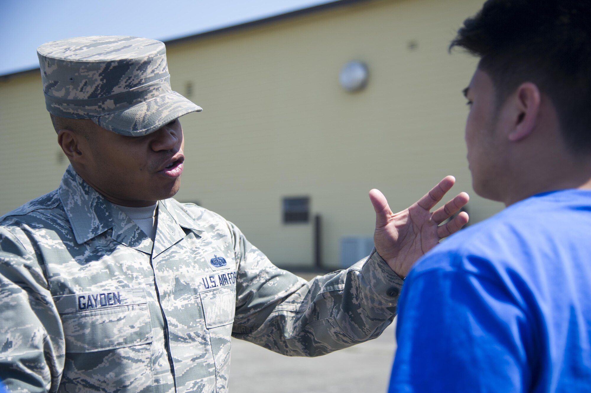 Tech. Sgt. Marc Gayden, Beale Honor Guard team lead, speaks to a trainee assigned to the 940th Air Refueling Wing’s Development and Training Flight April 9, 2017, at Beale Air Force Base, California. Trainees in the D&TF are preparing for basic military training. (U.S. Air Force photo by Senior Airman Tara R. Abrahams)