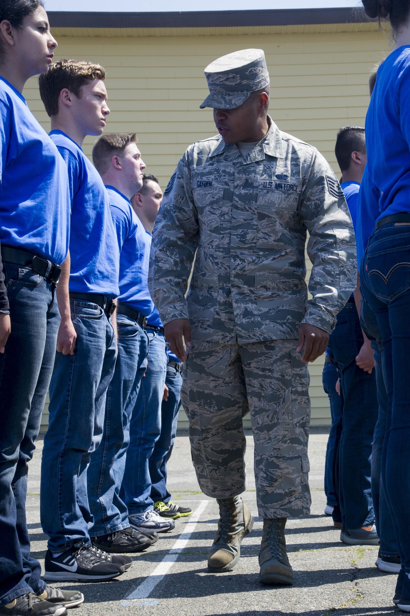 Tech. Sgt. Marc Gayden, Beale Honor Guard team lead, evaluates trainees assigned to the 940th Air Refueling Wing’s Development and Training Flight in the position of attention April 9, 2017, at Beale Air Force Base, California. Gayden taught the flight how to stand, execute facing movements and render a salute. (U.S. Air Force photo by Senior Airman Tara R. Abrahams)