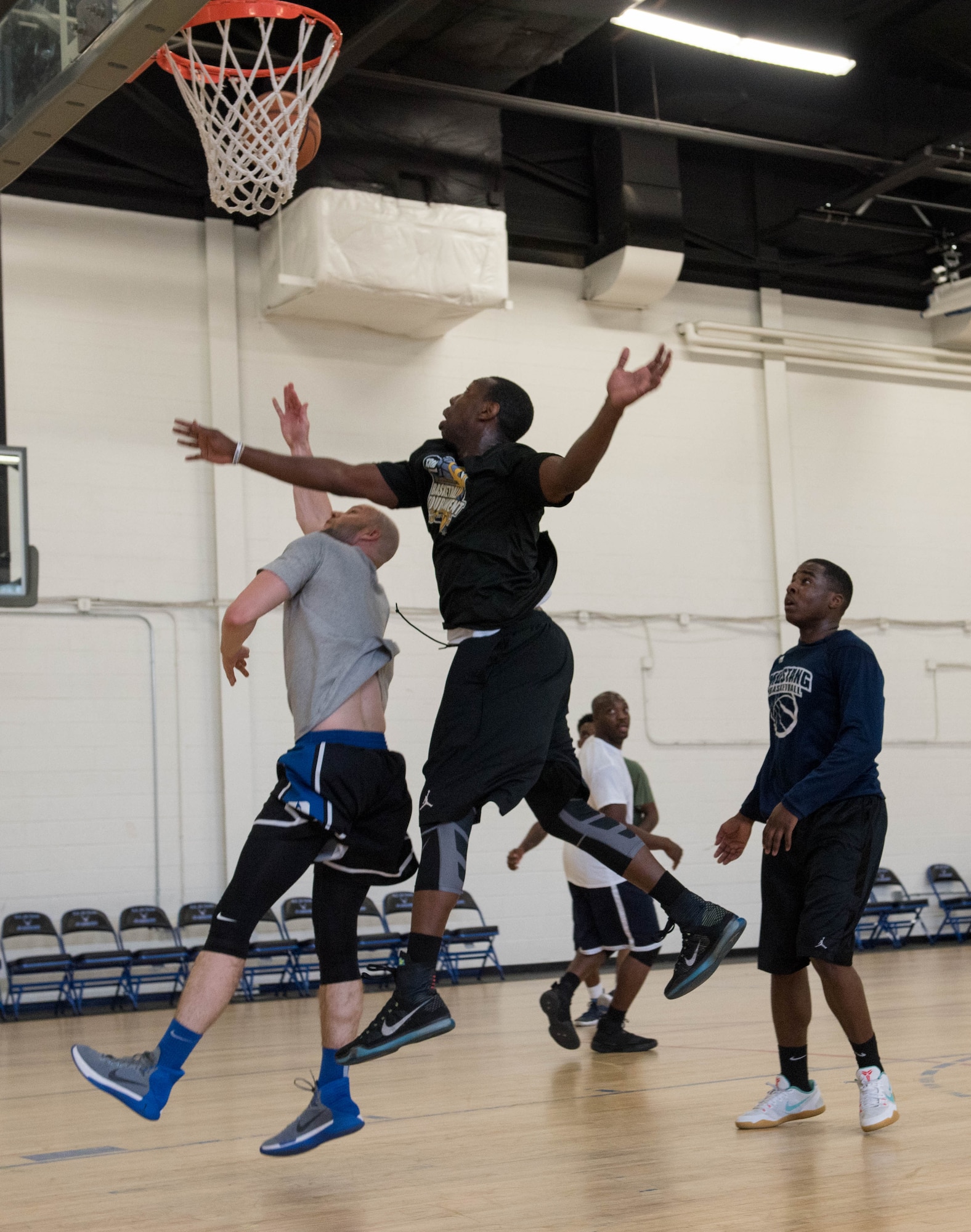 Joint Base Andrews members play in a three-on-three basketball game at the West Fitness Center on JBA, Md., April 14, 2017. The game was part of a fundraising tournament supporting the Air Force Assistance Fund campaign.  Air Force bases worldwide participate in this campaign, raising money for four Air Force charities: Air Force Aid Society, Air Force Enlisted Village, Air Force Villages Charitable Foundation and the General and Mrs. Curtis E. LeMay Foundation.  (U.S. Air Force photo by Airman 1st Class Rustie Kramer)