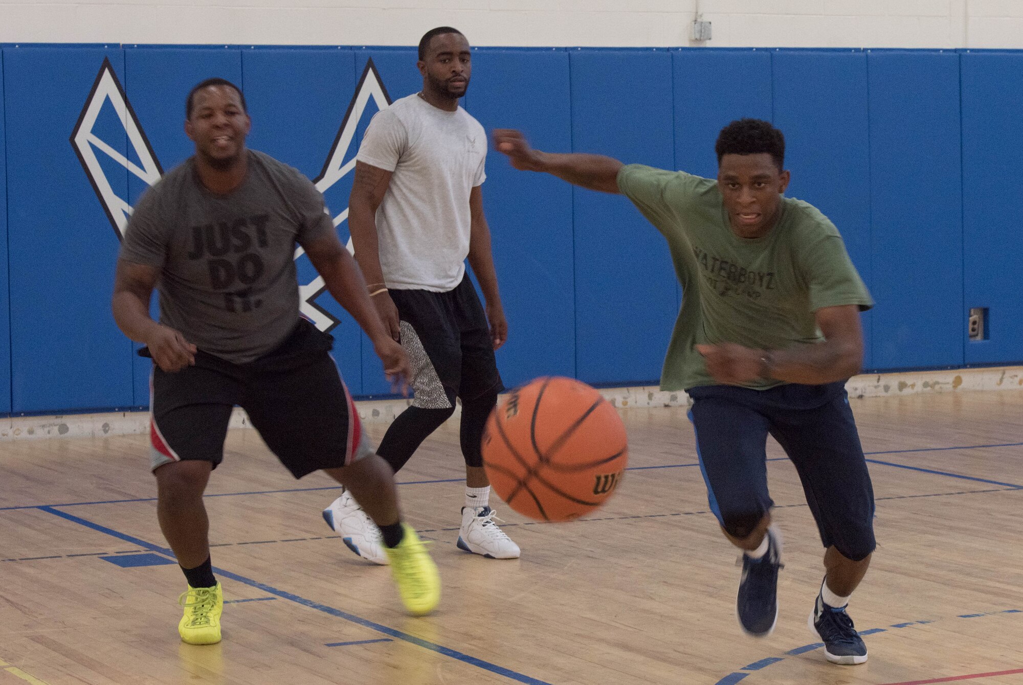 Joint Base Andrews members race for a loose ball during three-on-three basketball game at the West Fitness Center on JBA, Md., April 14, 2017. The game was part of a fundraising tournament supporting the Air Force Assistance Fund campaign.  Air Force bases worldwide participate in this campaign, raising money for four Air Force charities: Air Force Aid Society, Air Force Enlisted Village, Air Force Villages Charitable Foundation and the General and Mrs. Curtis E. LeMay Foundation.  (U.S. Air Force photo by Airman 1st Class Rustie Kramer)