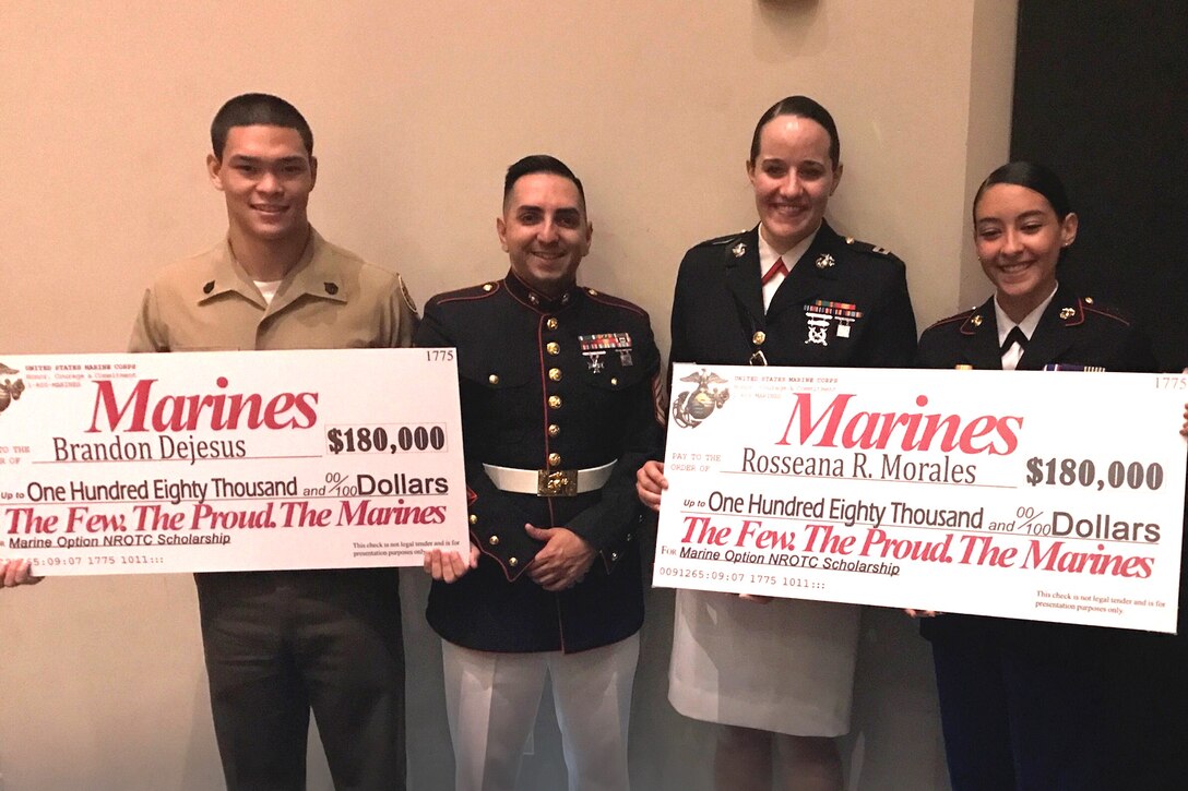 Captain Jennifer Mozzetta, executive officer for Recruiting Station Orlando, and Gunnery Sgt. Wilbert Vargas, station commander for Recruiting Substation Kissimmee, present Brandon Dejesus and Rosseana Morales with the Naval Reserve Officer Training Scholarship at Gateway High School, Kissimmee, FL April 12, 2017. The scholarship is extremely competitive and only the most qualified individuals who exhibit outstanding characteristics are selected.  