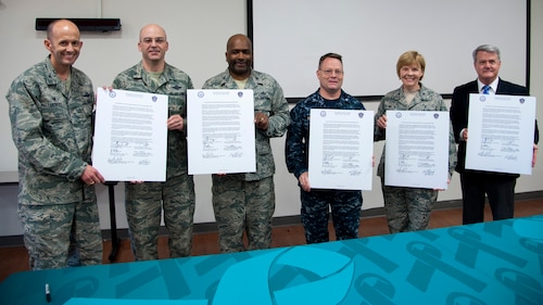 Base leadership pose for a photograph at Joint Base Andrews, Md., April 6, 2017. Leadership gathered to sign a Sexual Assault Awareness and Prevention Month 2017 proclamation that kicked off the month’s various events. (U.S. Navy photo by Petty Officer 1st Class Ernesto Hernandez Fonte)