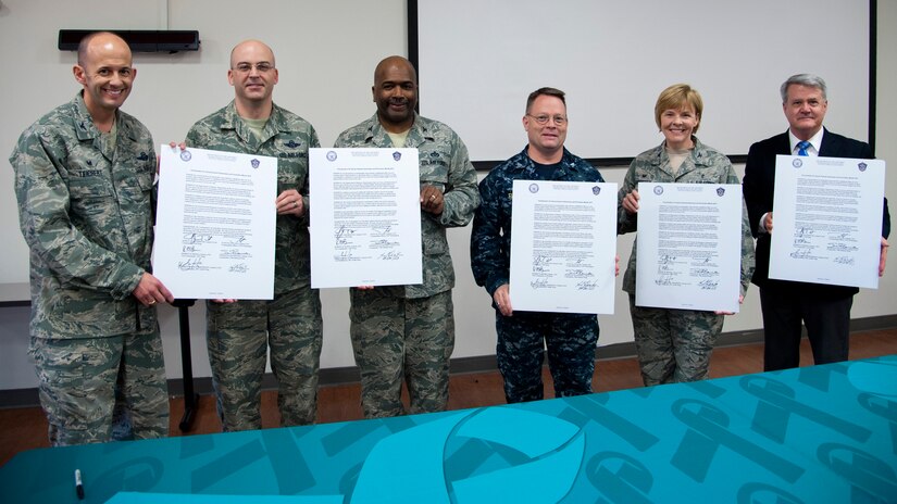 Base leadership pose for a photograph at Joint Base Andrews, Md., April 6, 2017. Leadership gathered to sign a Sexual Assault Awareness and Prevention Month 2017 proclamation that kicked off the month’s various events. (U.S. Navy photo by Petty Officer 1st Class Ernesto Hernandez Fonte)
