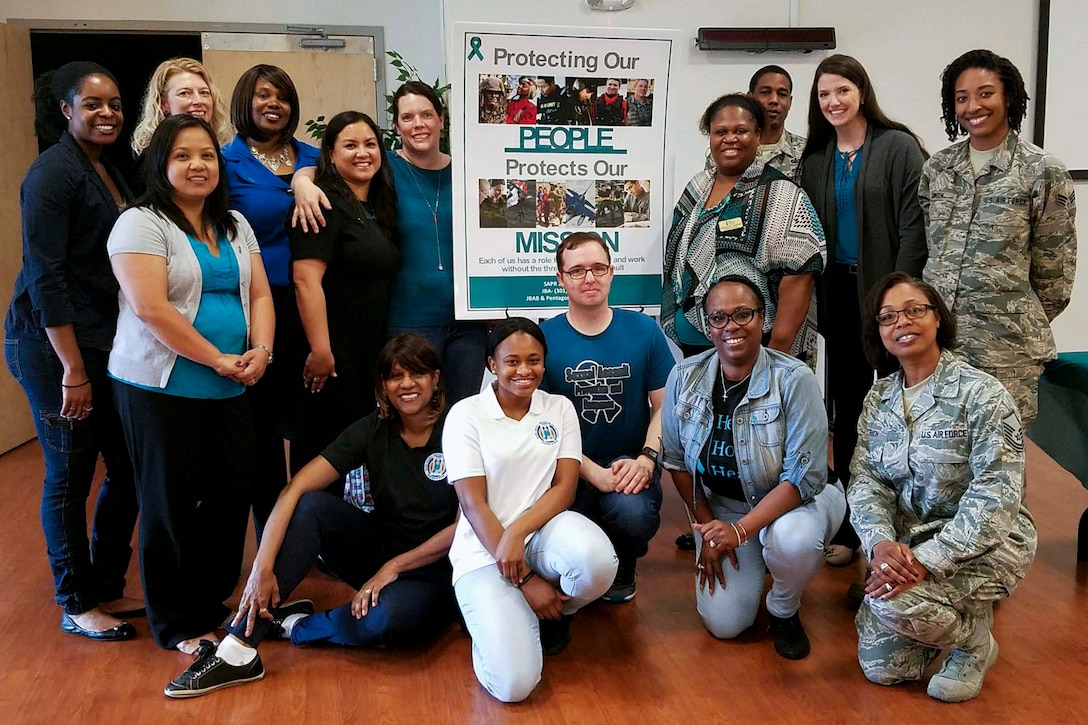 Sexual Assault Awareness and Prevention Month proclamation signing participants pose for a photo at Joint Base Andrews, Md., April 6, 2017. The signing was one of multiple SAAPM events meant to raise cognizance about sexual harassment and violence, and inform military members about how to prevent it. (courtesy photo)