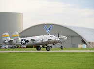 The B-25 Mitchell bomber Miss Mitchell lands on a runway next to the National Museum of the U.S. Air Force at Wright-Patterson Air Force Base, Ohio, April 17, 2017. The Miss Mitchell is one of the 11 World War II bombers taking part in the museum’s celebration of the 75th anniversary of the Doolittle Raid when Army Air Corps bombers took off from an aircraft carrier to deliver the first strike of the war on the Japanese homeland. (U.S. Air Force photo by R.J. Oriez/Released)