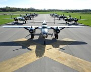 B-25 Mitchell bombers sit parked in a runway next to the National Museum of the U.S. Air Force at Wright-Patterson Air Force Base, Ohio, April 17, 2017. The 11 World War II era bombers landed at the museum to take part in its celebration of the 75th anniversary of the Doolittle Raid when Army Air Corps bombers took off from an aircraft carrier to deliver the first strike of the war on the Japanese homeland. (U.S. Air Force photo by R.J. Oriez/Released)