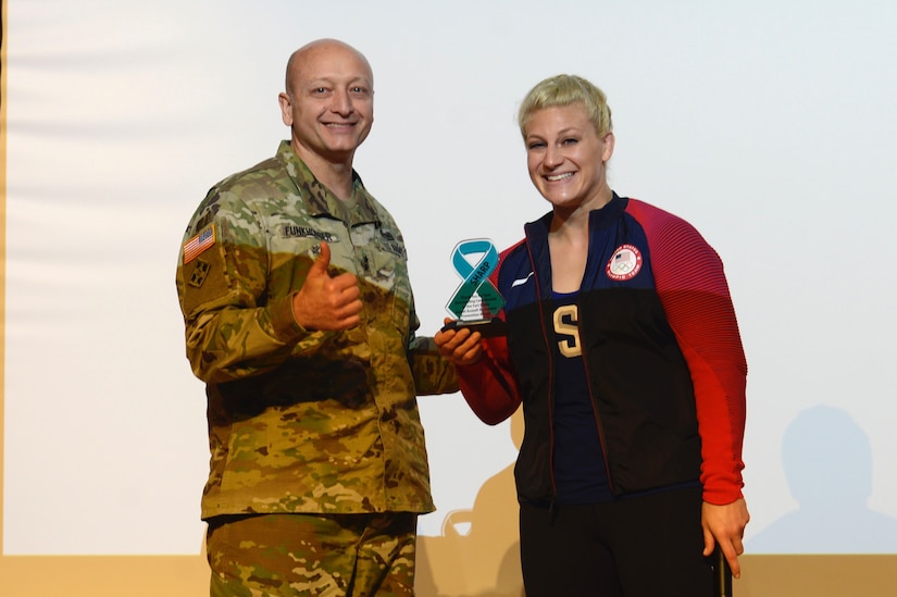 U.S. Army Maj. Gen. Anthony Funkhouser, Center for Initial Military Training commander, presents Kayla Harrison, Olympic Gold Medalist and guest speaker, with a gift during a Sexual Assault Awareness and Prevention Month event at Joint Base Langley-Eustis, Va., April 14, 2017. Harrison, a Judo player, began to tell her story  about her sexual assault experience last year after winning her second gold medal at the 2016 Olympics. (U.S. Air Force photo/Airman 1st Class Kaylee Dubois)