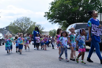 Members of Team Charleston participate in a parade outside the Childcare Development Center here for a Month of the Military Child celebration, April 14, 2017. April is designated as Month of the Military Child to recognize the 1.7 million military children across the globe and the sacrifices they make alongside their parents.