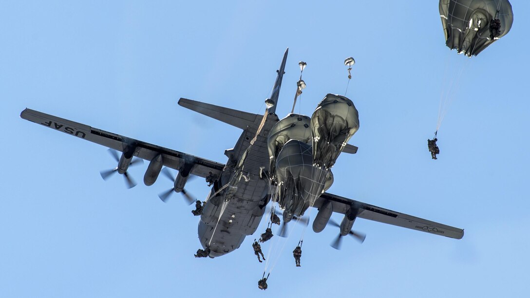 Soldiers jump from a Nevada Air National Guard C-130H Hercules during airborne training at Joint Base Elmendorf-Richardson, Alaska, April 13, 2017. The soldiers are paratroopers are assigned to the 25th Infantry Division's 1st Battalion, 501st Parachute Infantry Regiment, 4th Infantry Brigade Combat Team (Airborne), U.S. Army Alaska. The soldiers are trained to execute airborne maneuvers in extreme cold weather and high-altitude environments to support combat, partnership and disaster relief operations. Air Force photo by Alejandro Pena