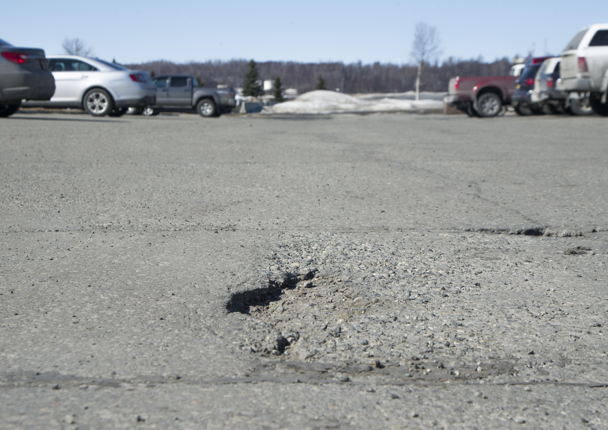 Spring is finally here, which means it can create numerous problems on the roads such as potholes. Potholes result when water gets into and under asphalt. The 773rd Civil Engineer Squadron recommends drivers stay away from the road edges and increase following distance to give you ample time to reach when there is a pothole, and stay vigilant in areas with a lot of standing waters on the road. (U.S. Air Force photo by Staff Sgt. Sheila deVera)

