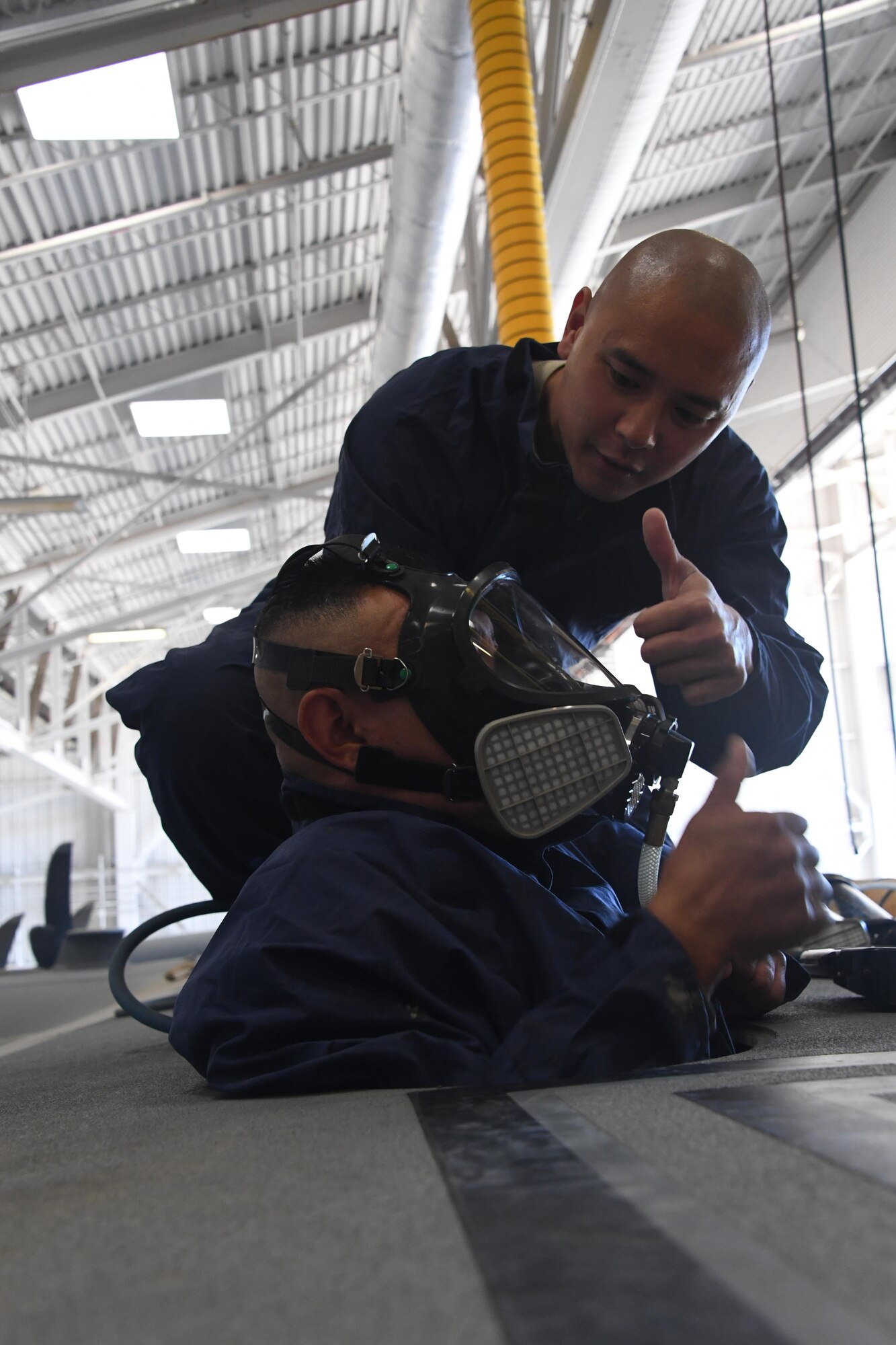 U.S. Air National Guard members Senior Airman Allan Tan assists Senior Airman Pedro Pescador with the 146th Airlift Wing’s Aircraft Fuel Systems Maintenance Squadron as he inserts himself into inside of a wing of a C-130J aircraft for a “confined space rescue exercise” at the Channel Islands Air National Guard Station Port Hueneme, Calif. April 1, 2017. During a confined space rescue exercise, first-responders with the 146th Airlift Wing’s Aircraft Fuel Systems Maintenance Squadron and Federal Fire Ventura County firefighters run through the critical emergency operations that would take place if a fuel-cell maintenance worker were to become incapacitated while working inside the very small fuel tanks inside the aircraft’s wings. (U.S. Air National Guard photo by: Staff Sgt. Nieko Carzis.)