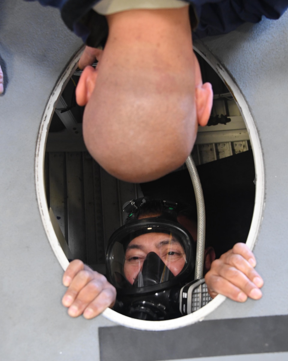 U.S. Air National Guard members Senior Airman Allan Tan assists Senior Airman Pedro Pescador with the 146th Airlift Wing’s Aircraft Fuel Systems Maintenance Squadron as he inserts himself into inside of a wing of a C-130J aircraft for a “confined space rescue exercise” at the Channel Islands Air National Guard Station Port Hueneme, Calif. April 1, 2017. During a confined space rescue exercise, first-responders with the 146th Airlift Wing’s Aircraft Fuel Systems Maintenance Squadron and Federal Fire Ventura County firefighters run through the critical emergency operations that would take place if a fuel-cell maintenance worker were to become incapacitated while working inside the very small fuel tanks inside the aircraft’s wings. (U.S. Air National Guard photo by: Staff Sgt. Nieko Carzis.)