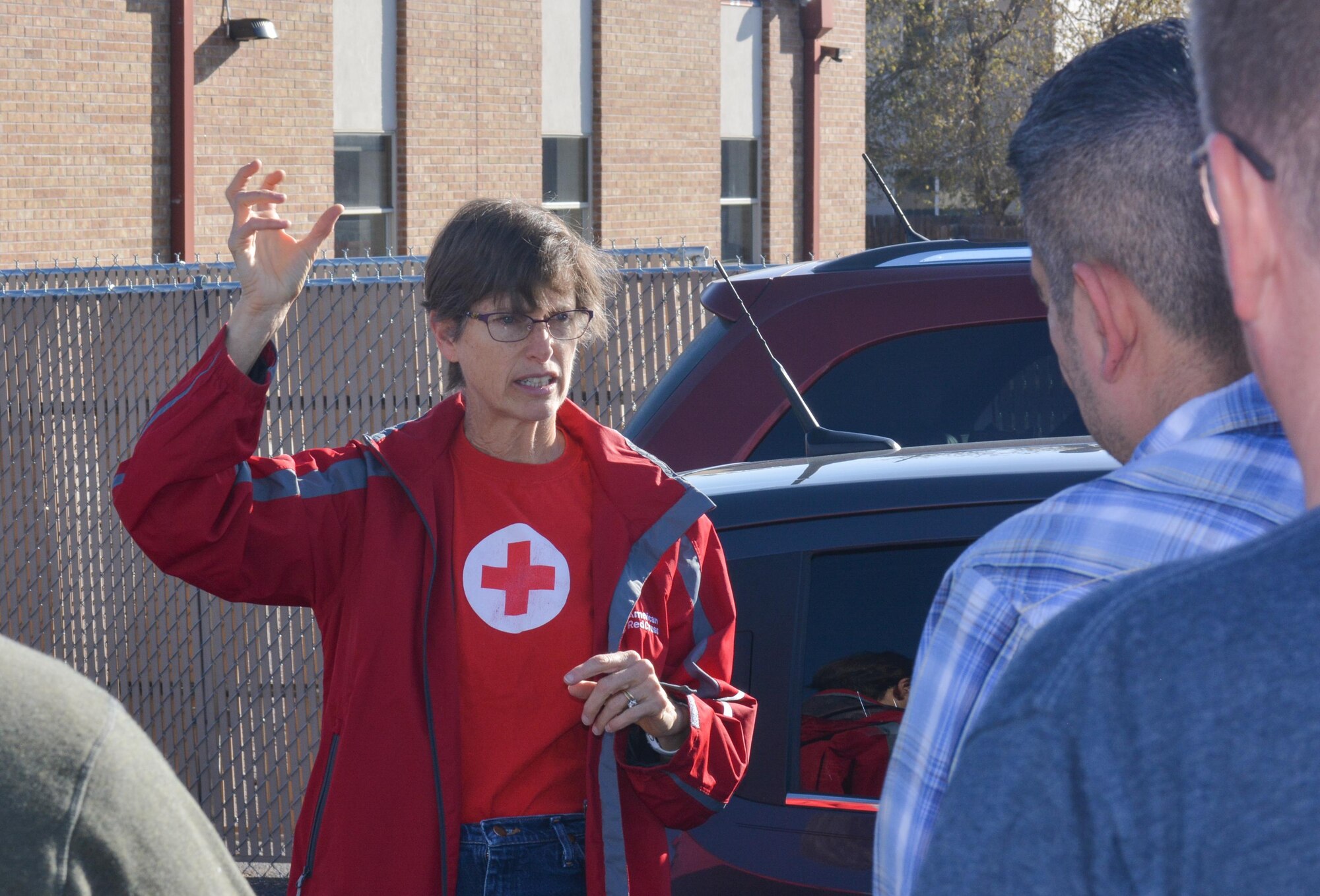 SCHREIVER AIR FORCE BASE, Colo. -- Sally Broomfield, Disaster Program Manager for Southeastern Colorado's American Red Cross, instructs 310th Space Wing volunteers on how to install fire alarms for families in the Cimarron Hills community during a Home Fire Campaign event on Saturday, Apr. 15th, 2017. The Red Cross responds to approximately 64,000 disasters each year with the vast majority being home fires, resulting in a goal to reduce fire-related deaths and injuries. (U.S. Air Force photo/Senior Airman Laura Turner)