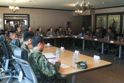 Service members from the Republic of Korea, Japan and the United States discuss various topics at a trilateral symposium at Yongsan Garrison, April 12. The purpose of the trilateral symposium is to extend and share information on officers' leadership, duties and responsibilities and to shape and foster a better relationship for future endeavors. 