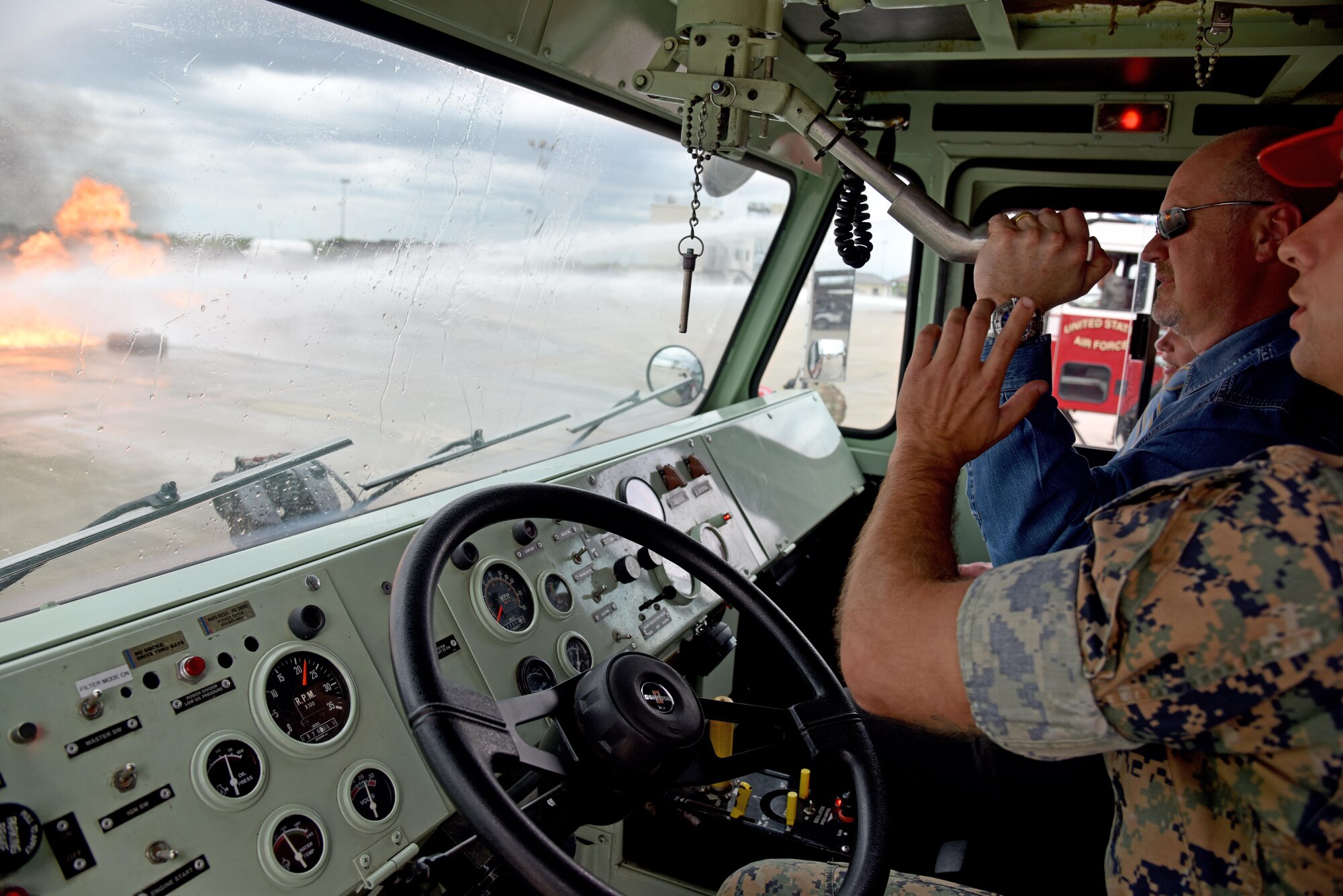 U.S. Marine Corps Sgt. Alex Blackwell, 312th Training Squadron instructor, teaches Stephanie Hamby and Ed Harris, Leadership San Angelo members, who to use one of the fire engines at the Louis F. Garland Department of Defense Fire Academy on Goodfellow Air Force Base, Texas, April 13, 2017. The fire academy was the last stop for LSA during their trip to Goodfellow.  (U.S. Air Force photo by Staff Sgt. Joshua Edwards/Released)