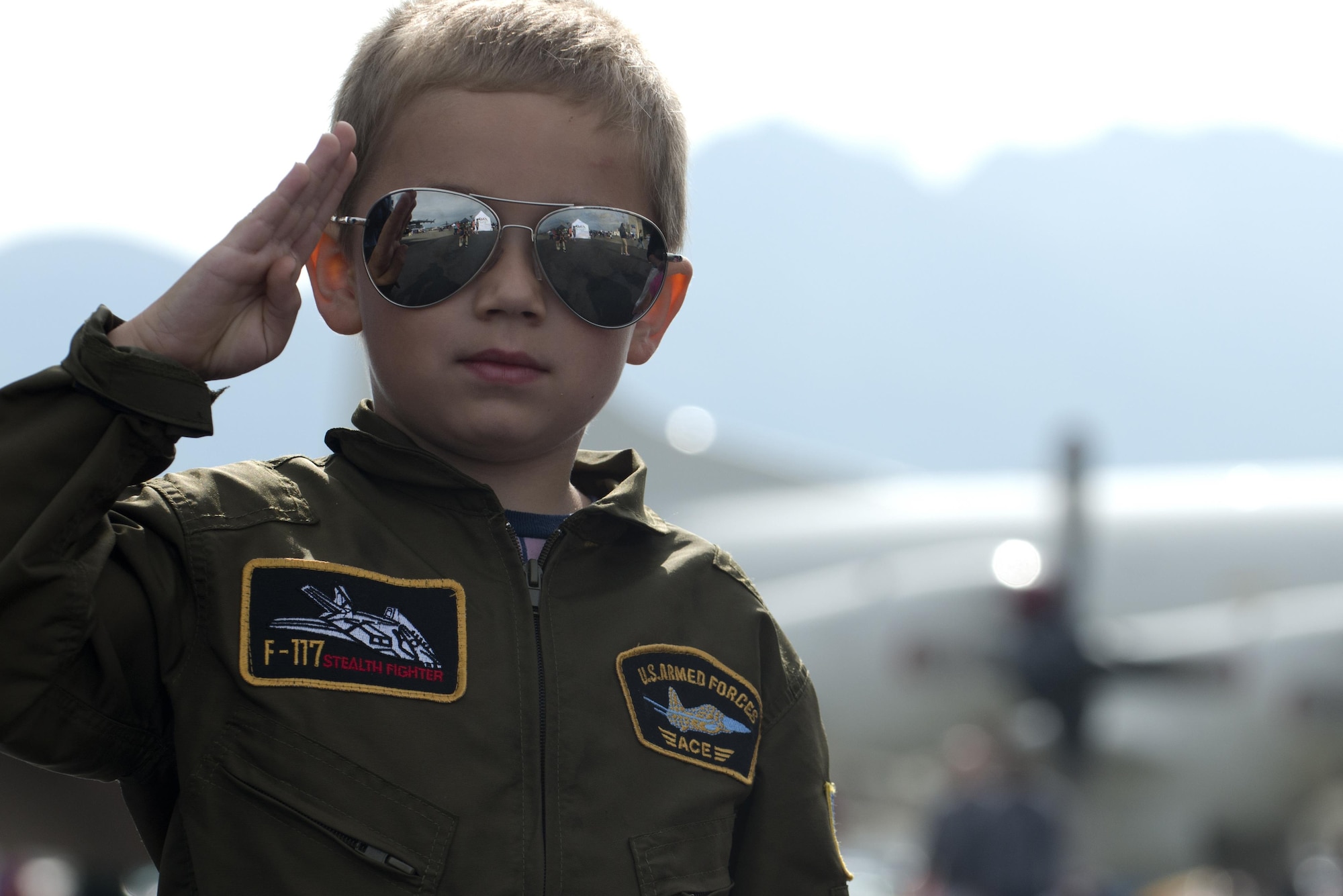 Riley Gustafson, 5, grandson of U.S. Air Force retired Master Sgt. James Barnett, salutes a passing Airman, July 31, 2016. The Month of the Military Child is a time to honor the important role military children play in the armed forces community. 