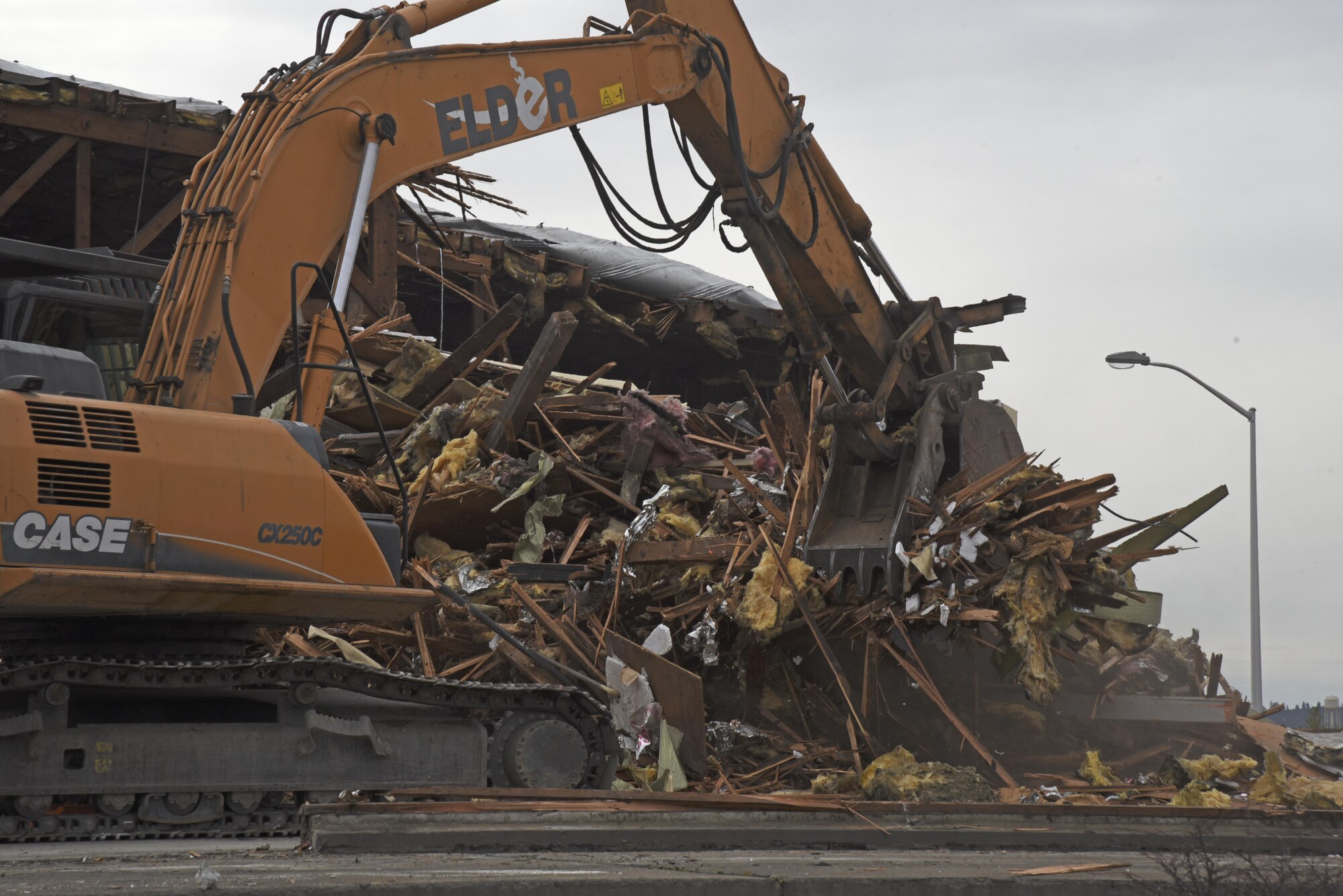 The 92nd Logistics Readiness Squadron's vehicle operations building is torn down April 5, 2017 at Fairchild Air Force Base, Wash. The building was torn down as part of Fairchild’s goal to remove hazardous materials which could potentially affect Air Force personnel. (U.S. Air Force photo/Senior Airman Mackenzie K. Richarson)