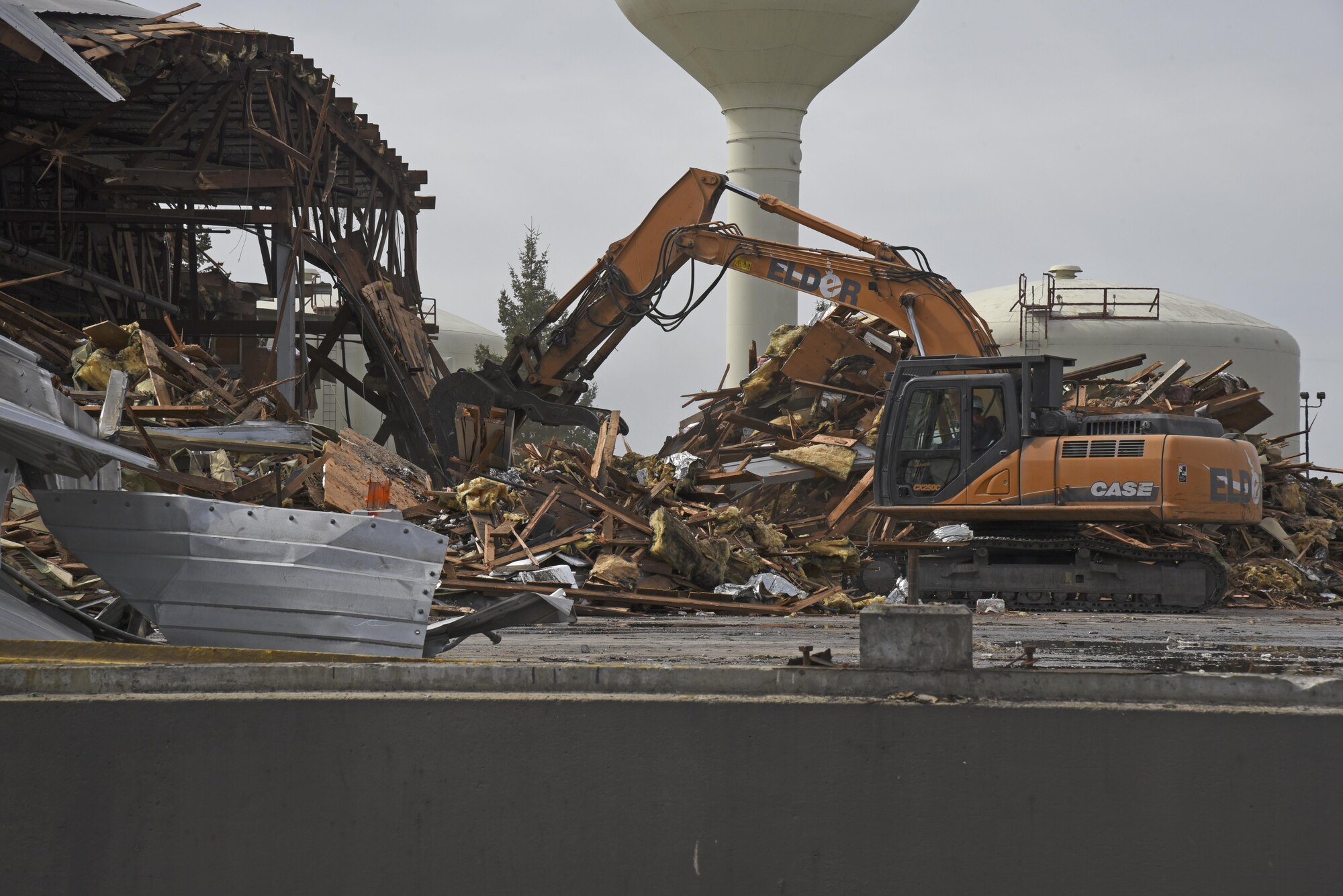 The old 92nd Logistics Readiness vehicle operations building is torn down to reduce utility and maintenance cost, April 5, 2017 at Fairchild Air Force Base Wash. The total period of teardown and removal of all debris will take 365 days and includes design, physical and closeout parts. (U.S. Air Force photo/Senior Airman Mackenzie K. Richardson)