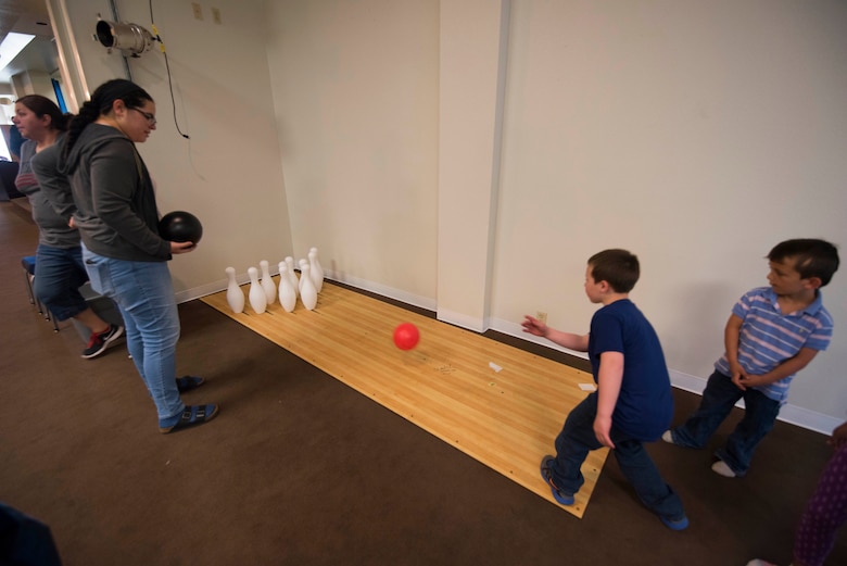 A child bowls during the Spring Fling Carnival at F.E. Warren Air Force Base, Wyo., April 15, 2017. Multiple activities were open for children to play to include bucket fishing, bean bag toss and bowling. The 90th Force Support Squadron held the event for the local community to mark the start of spring and bring families together for a fun event. (U.S. Air Force photo by Staff Sgt. Christopher Ruano)