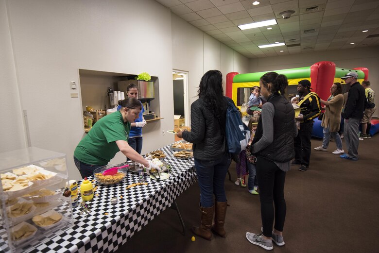 Attendees line up for food during the Spring Fling Carnival at F.E. Warren Air Force Base, Wyo., April 15, 2017. Free food was provided to all those who attended the carnival. The 90th Force Support Squadron held the event for the local community to mark the start of spring and bring families together for a fun event. (U.S. Air Force photo by Staff Sgt. Christopher Ruano)