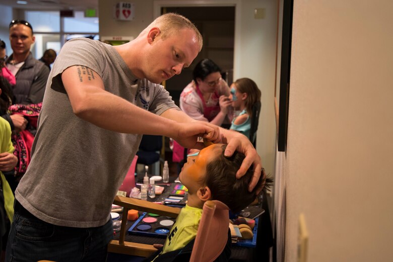 Face painters decorate children’s faces during the Spring Fling Carnival at F.E. Warren Air Force Base, Wyo., April 15, 2017. More than 100 families participated in the Spring Fling Carnival. The 90th Force Support Squadron held the event for the local community to mark the start of spring and bring families together for a fun event. (U.S. Air Force photo by Staff Sgt. Christopher Ruano)