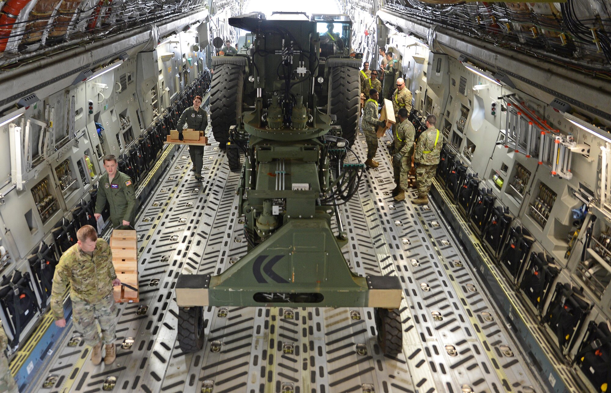 Soldiers from the 13th Combat Sustainment Support Battalion work with Airmenn from the 62nd Airlift Wing to tie down a Rough Terrain Container Handler in a C-17 Globemaster III during a Mission Oriented Training exercise April 13, 2017, at Joint Base Lewis-McChord, Wash. Prior to the exercise, dunnage had to be built and had to meet the specifications of the load plan for loading a RTCH on a C-17. (U.S. Air Force photo/Senior Airman Jacob Jimenez)    