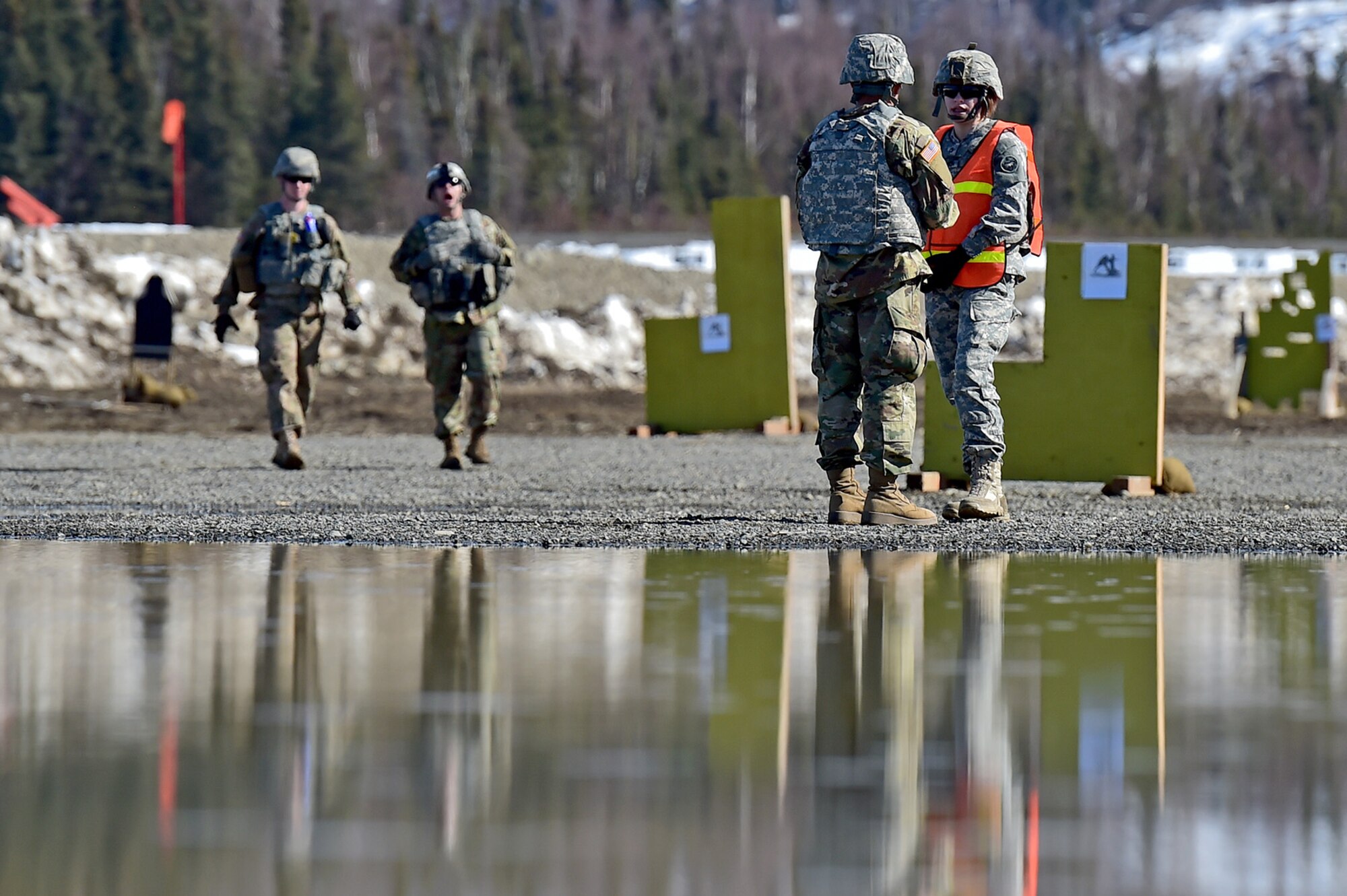 Range safety officers assigned to the 95th Chemical Company, “Arctic Dragons”, 17th Combat Sustainment Support Battalion, U.S. Army Alaska, wait for the next round of Soldiers to execute a Joint Service Lightweight Integrated Suit Technology stress fire at McGee range on Joint Base Elmendorf-Richardson, Alaska, April 13, 2017. The JSLIST is the product of a four-Service effort to field a common chemical protective clothing ensemble including a lightweight protective garment, multi-purpose overboots and gloves. 