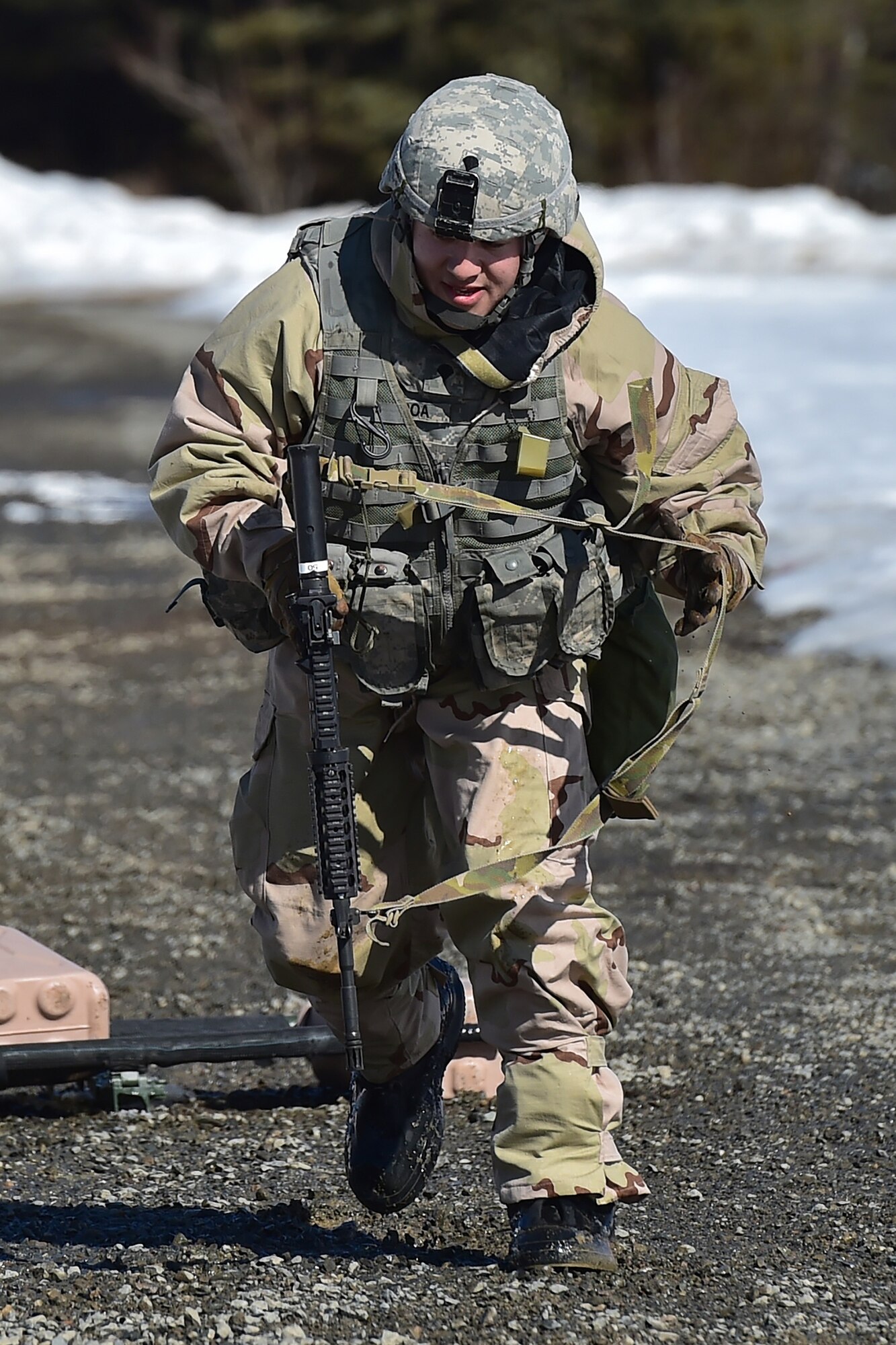 A soldier assigned to the 95th Chemical Company, “Arctic Dragons”, 17th Combat Sustainment Support Battalion, U.S. Army Alaska, performs a three-to-five second rush while preparing to execute a Joint Service Lightweight Integrated Suit Technology stress fire at McGee range on Joint Base Elmendorf-Richardson, Alaska, April 13, 2017. The JSLIST is the product of a four-Service effort to field a common chemical protective clothing ensemble including a lightweight protective garment, multi-purpose overboots and gloves. 