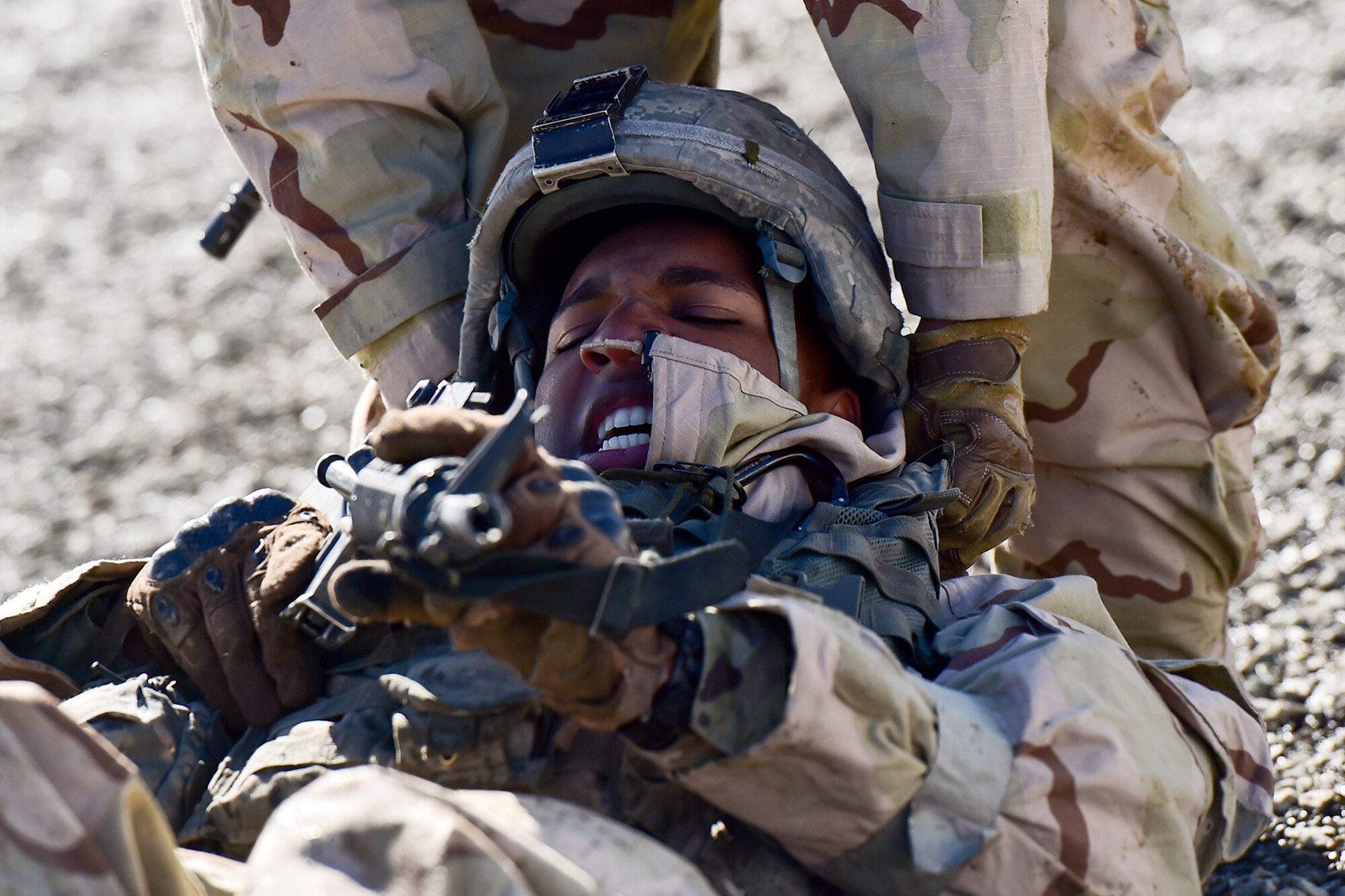 Spc. Diego Adamski, a native of Shelton, Wash., assigned to the 95th Chemical Company, “Arctic Dragons”, 17th Combat Sustainment Support Battalion, U.S. Army Alaska, simulates a wounded soldier and is dragged by Army Pfc. Esteban Guerrero, a native of Modesto, Calif., to raise their heart rates before executing a Joint Service Lightweight Integrated Suit Technology stress fire at McGee range on Joint Base Elmendorf-Richardson, Alaska, April 13, 2017. The JSLIST is the product of a four-Service effort to field a common chemical protective clothing ensemble including a lightweight protective garment, multi-purpose overboots and gloves. 