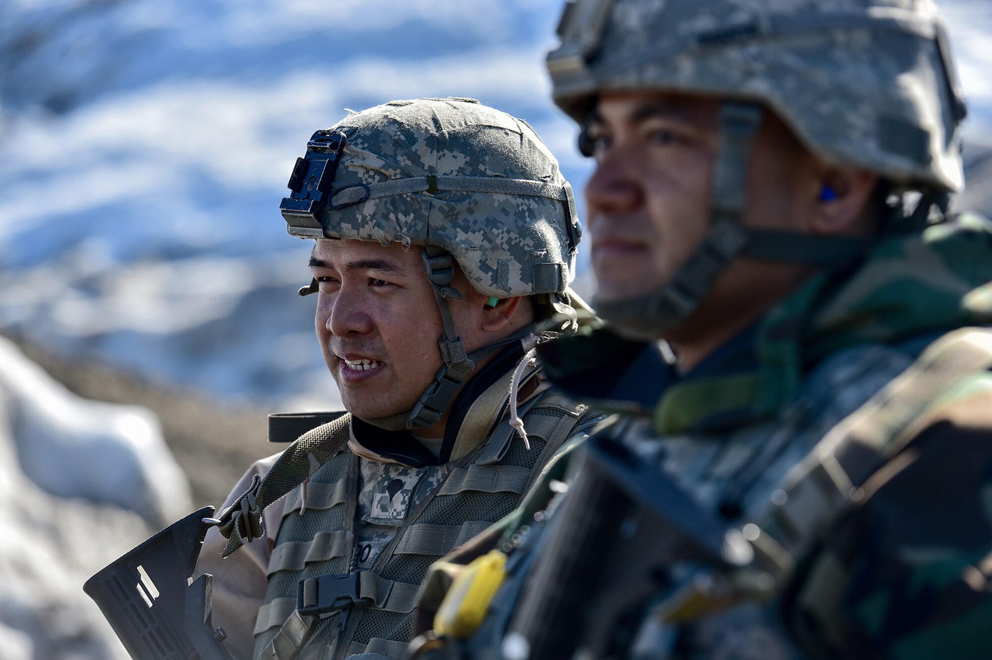 Spc. Francis Lucredo, a native of Los Angeles, left, and Army Staff Sgt. Norbert Iriarte, a native of Mangilao, Guam, both assigned to the 95th Chemical Company, “Arctic Dragons”, 17th Combat Sustainment Support Battalion, U.S. Army Alaska, wait to execute a Joint Service Lightweight Integrated Suit Technology stress fire at McGee range on Joint Base Elmendorf-Richardson, Alaska, April 13, 2017. The JSLIST is the product of a four-Service effort to field a common chemical protective clothing ensemble including a lightweight protective garment, multi-purpose overboots and gloves.