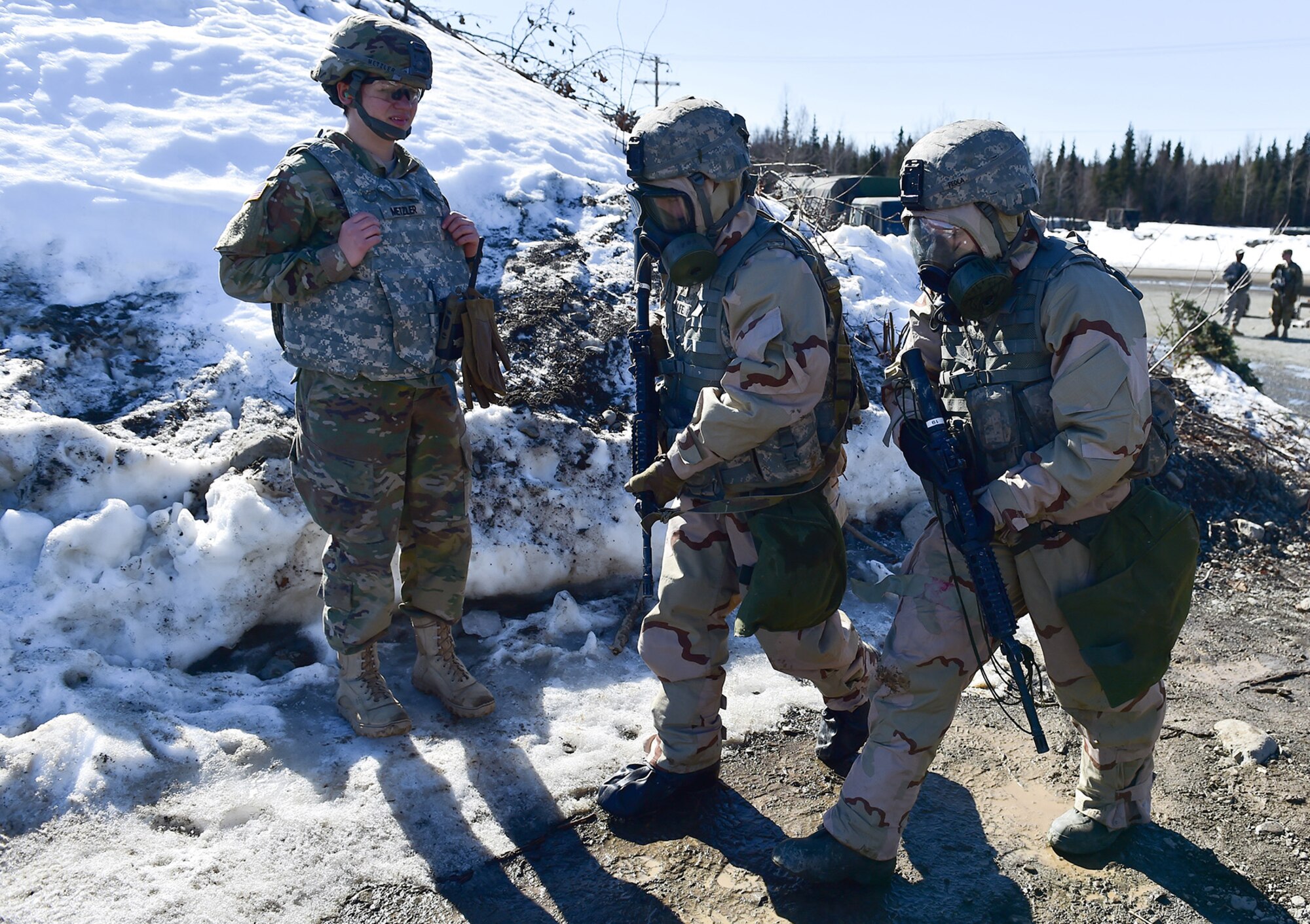 Army 2nd Lt. Jenny Metzler, left, watches Spc. Michael Forlife, a native of Brooklyn, and Spc. Katie McCarthy, a native of Punta Gorda, Fla., all assigned to the 95th Chemical Company, “Arctic Dragons”, 17th Combat Sustainment Support Battalion, U.S. Army Alaska,  prepare to execute a Joint Service Lightweight Integrated Suit Technology stress fire at McGee range on Joint Base Elmendorf-Richardson, Alaska, April 13, 2017. The JSLIST is the product of a four-Service effort to field a common chemical protective clothing ensemble including a lightweight protective garment, multi-purpose overboots and gloves. 
