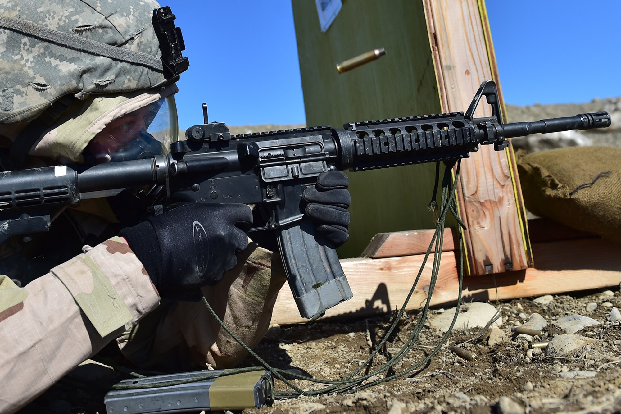 Spc. Katie McCarthy, a native of Punta Gorda, Fla., assigned to the 95th Chemical Company, “Arctic Dragons”, 17th Combat Sustainment Support Battalion, U.S. Army Alaska, fires her M4 carbine at a target during a Joint Service Lightweight Integrated Suit Technology stress fire at McGee range on Joint Base Elmendorf-Richardson, Alaska, April 13, 2017. The JSLIST is the product of a four-Service effort to field a common chemical protective clothing ensemble including a lightweight protective garment, multi-purpose overboots and gloves. 