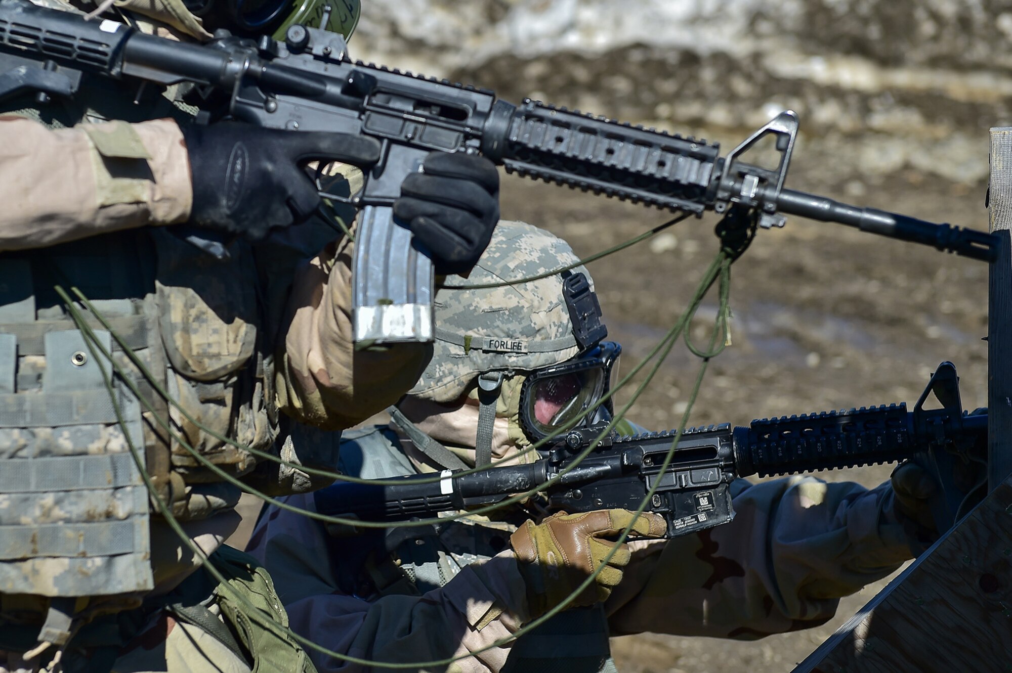 Spc. Michael Forlife, a native of Brooklyn, assigned to the 95th Chemical Company, “Arctic Dragons”, 17th Combat Sustainment Support Battalion, U.S. Army Alaska, prepares to reload his M4 carbine as his battle buddy Spc. Katie McCarthy, a native of Punta Gorda, Fla., raises her weapon to accuire a target while executing a Joint Service Lightweight Integrated Suit Technology stress fire at McGee range on Joint Base Elmendorf-Richardson, Alaska, April 13, 2017. The JSLIST is the product of a four-Service effort to field a common chemical protective clothing ensemble including a lightweight protective garment, multi-purpose overboots and gloves. 