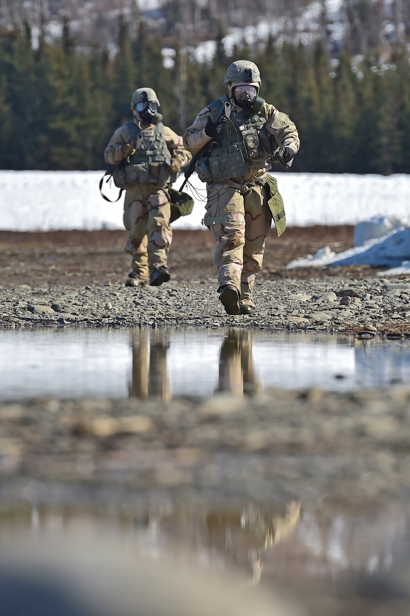 Soldiers assigned to the 95th Chemical Company, “Arctic Dragons”, 17th Combat Sustainment Support Battalion, U.S. Army Alaska, walk off the firing line after executing a Joint Service Lightweight Integrated Suit Technology stress fire at McGee range on Joint Base Elmendorf-Richardson, Alaska, April 13, 2017. The JSLIST is the product of a four-Service effort to field a common chemical protective clothing ensemble including a lightweight protective garment, multi-purpose overboots and gloves. 