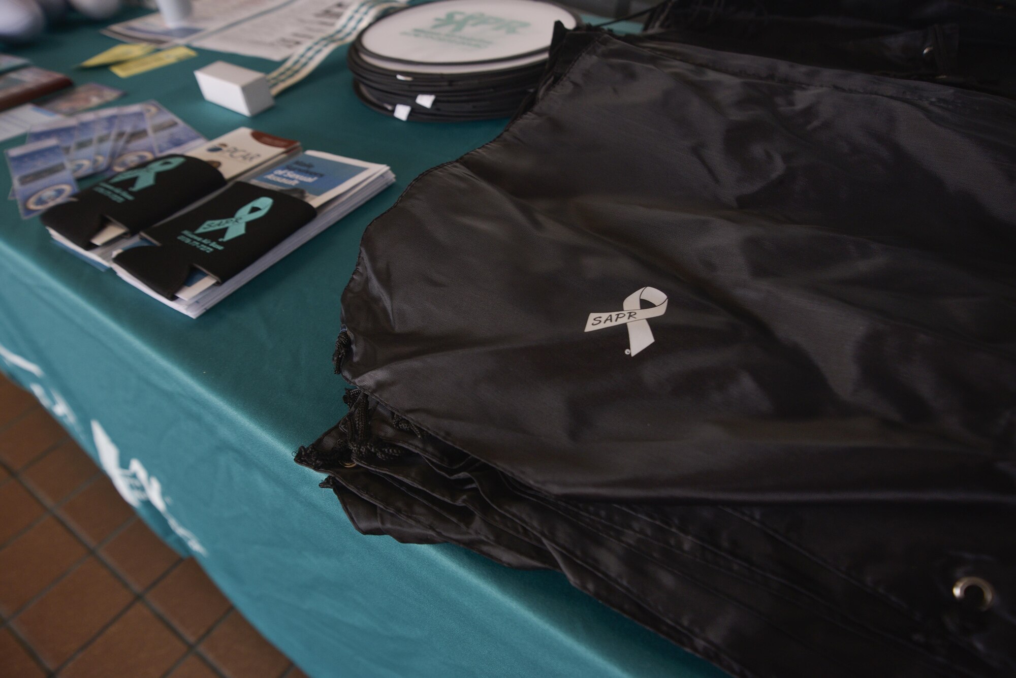 A table with a variety of Sexual Assault Prevention and Response branded items is setup in the foyer between the commissary and base exchange at Misawa Air Base, Japan, April 5, 2016. The table will be there through the month of April and will be manned by victim advocates on the weekend. (U.S. Air Force photo by Staff Sgt. Melanie Hutto)