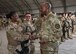 Chief Master Sgt. of the Air Force Kaleth O. Wright, recognizes Staff Sgt. Kiara Smith, Train, Advise, Assist Command-Air (TAAC-Air) intelligence advisor, for exceptional performance at Kabul Air Wing, Afghanistan, April 13, 2017. Gen. Stephen Wilson, Vice Chief of Staff of the Air Force; Wright; Maj. Gen. James Hecker, 9th Air and Space Expeditionary Task Force-Afghanistan commander; and Chief Master Sgt. Lisa Arnold, 9th AETF-A command chief; visited the 438th Air Expeditionary Wing and TAAC-Air. Brig. Gen. David Hicks, 438th AEW and TAAC-Air commander, and a contingent of TAAC-Air Coalition members and Afghan Air Force airmen gave the visitors a tour of AAF aircraft. Wilson thanked the group for their hard work and dedication to the mission. (U.S. Air Force photo by Tech. Sgt. Veronica Pierce)