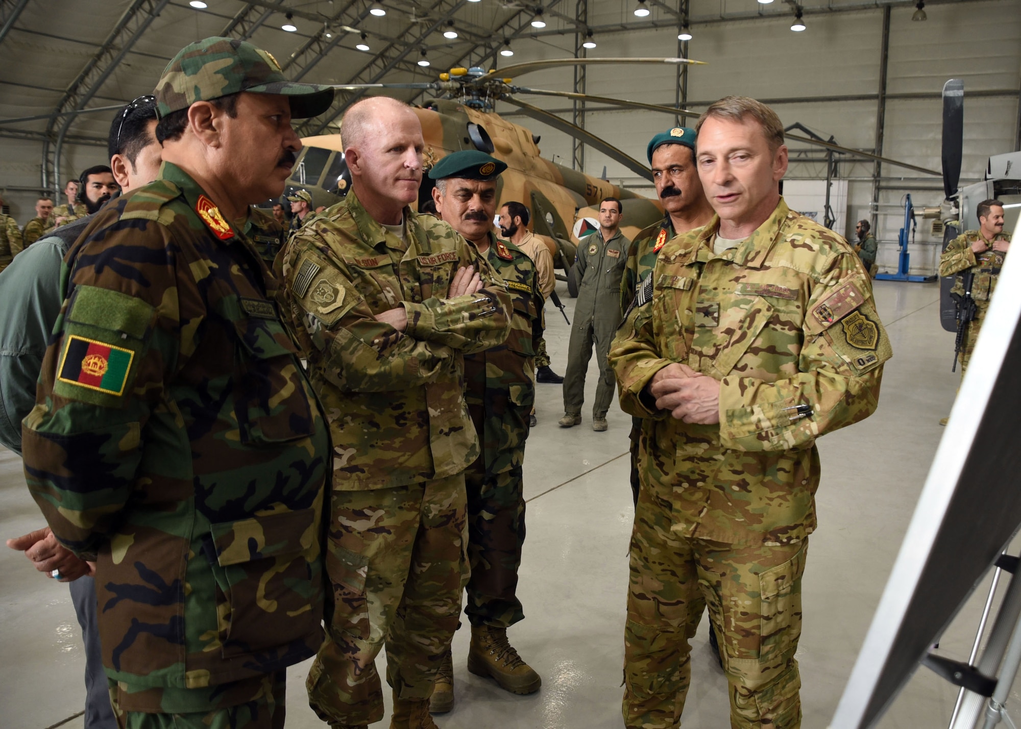 Brig. Gen. David Hicks, 438th Air Expeditionary Wing and Train, Advise, Assist Command-Air (TAAC-Air) commander, briefs Gen. Stephen Wilson, Vice Chief of Staff of the Air Force, about the success of the Afghan Air Force C-208 mission at Kabul Air Wing, Afghanistan, April 13, 2017. Wilson; Chief Master Sgt. of the Air Force Kaleth O. Wright; Maj. Gen. James Hecker, 9th Air and Space Expeditionary Task Force-Afghanistan commander; and Chief Master Sgt. Lisa Arnold, 9th AETF-A command chief; visited the 438th AEW and TAAC-Air. Hicks and a contingent of TAAC-Air Coalition and AAF members gave the visitors a tour of AAF aircraft. Wilson thanked the group for their hard work and dedication to the mission. (U.S. Air Force photo by Tech. Sgt. Veronica Pierce)
