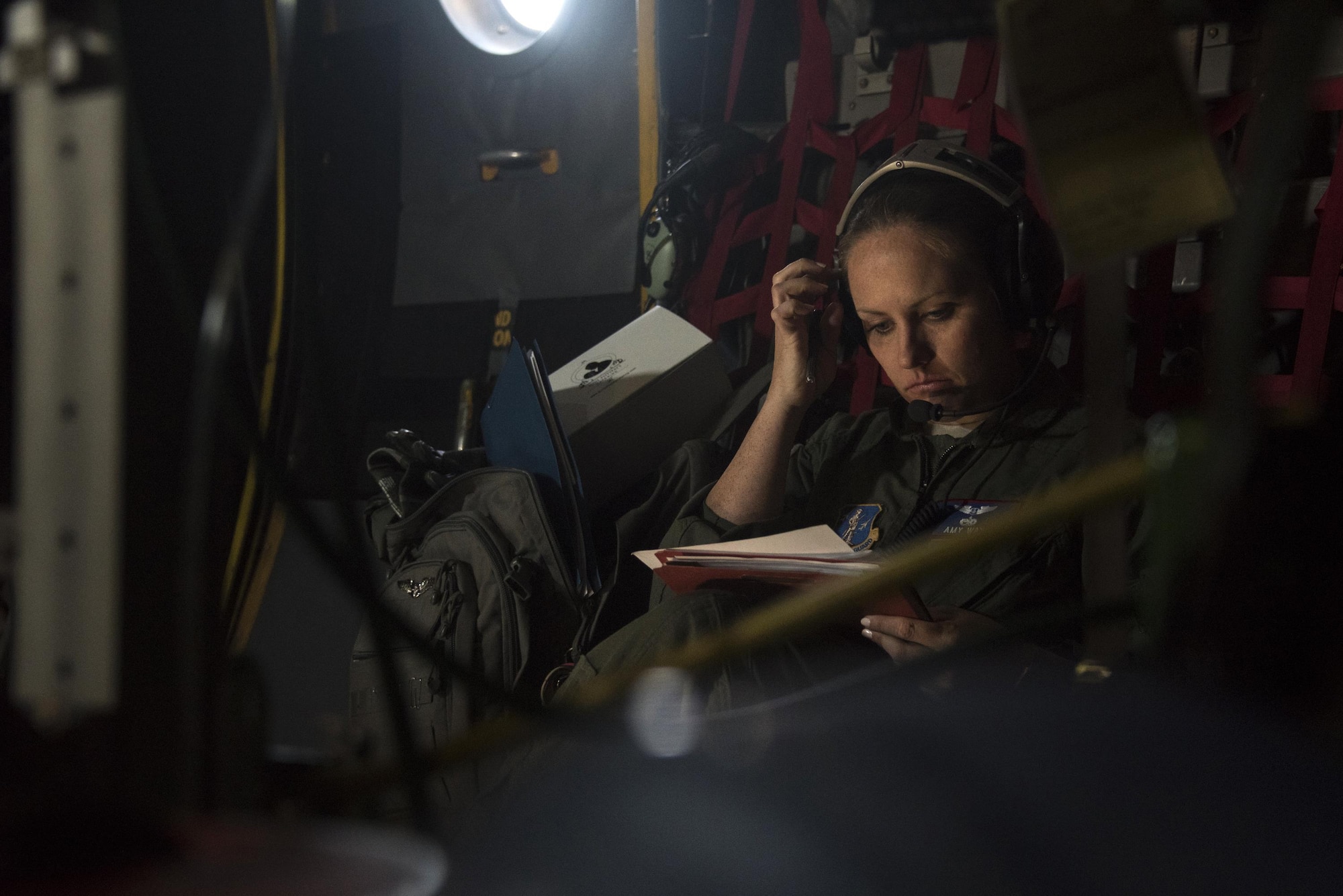 Capt. Amanda Wey, a flight nurse from the 183rd Aeromedical Evacuation Squadron, Mississippi Air National Guard, scans through checklists during a simulated flight on a static C-130 Hercules trainer at Will Rogers Air National Guard Base, April 7, 2017. The flight was part of the Multiple Aircraft Training Opportunity Program, or MATOP, that brought eight of the nine Air National Guard aeromedical evacuation squadrons and the three aircraft they most commonly fly on to one place for realistic and comprehensive training, April 6-9, 2017. (U.S. Air National Guard photo by Staff Sgt. Kasey Phipps)