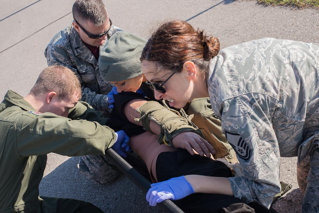 Airmen from the 109th Aeromedical Evacuation Squadron, Minnesota Air National Guard, navigate through an aeromedical-specific obstacle course at Will Rogers Air National Guard Base, Oklahoma City, during the Multiple Aircraft Training Opportunity Program (MATOP), April 7, 2017. Airmen of the 137 AES were joined by eight of the nine Air National Guard aeromedical evacuation squadrons as they hosted the annual training event and accomplished mandatory annual aeromedical training requirements. (U.S. Air National Guard photo by Senior Master Sgt. Andrew M. LaMoreaux/Released)