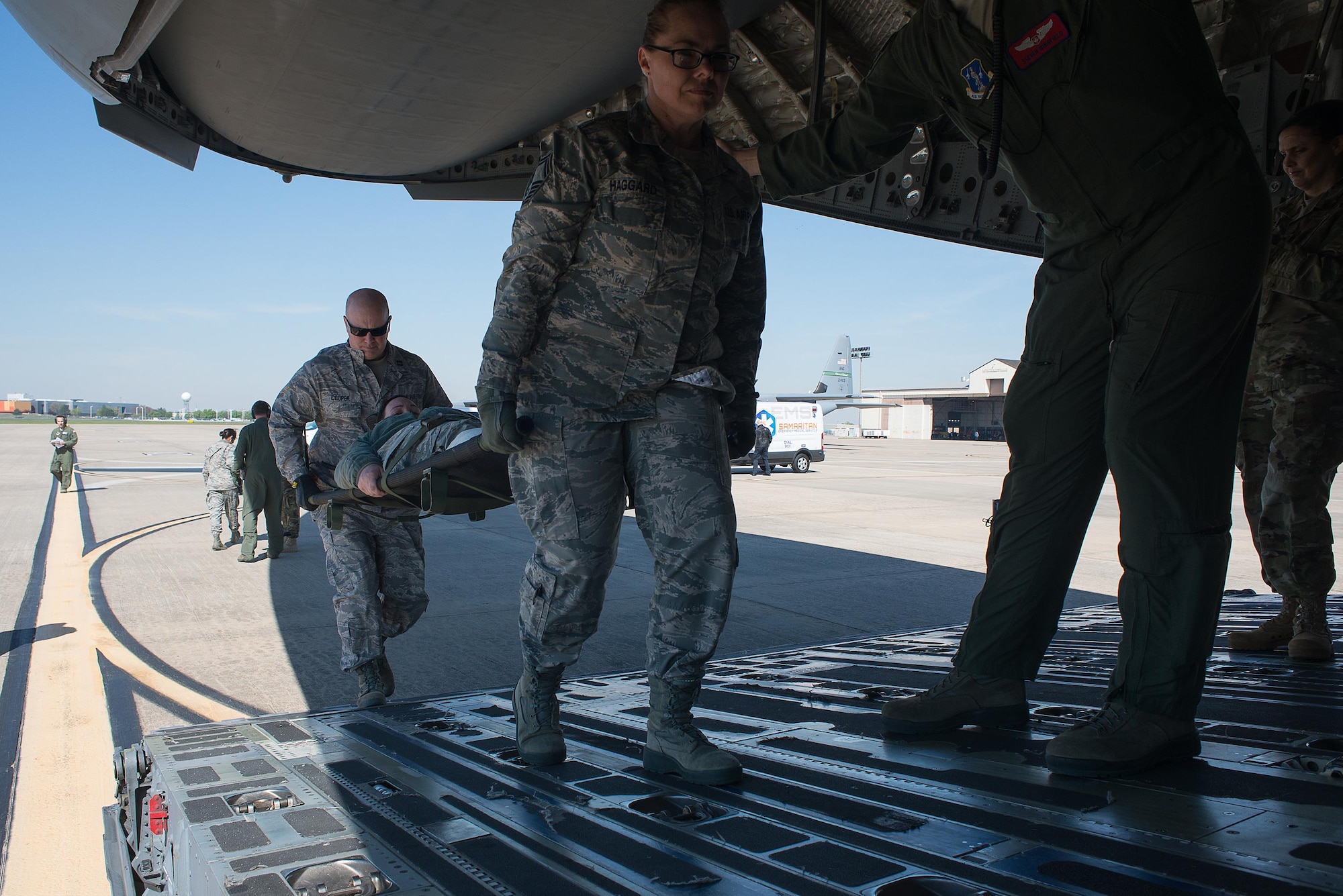 Tech. Sgt. Wendy Haggard and Capt. Patrick Cooper, both from the 137th Special Operations Medical Group, transport a simulated medical patient onto a C-17 Globemaster III at Will Rogers Air National Guard Base, Oklahoma City, during the Multiple Aircraft Training Opportunity Program (MATOP), April 7, 2017. Airmen of the 137 AES were joined by eight of the nine Air National Guard aeromedical evacuation squadrons as they hosted the annual training event and accomplished mandatory annual aeromedical training requirements. (U.S. Air National Guard photo by Senior Master Sgt. Andrew M. LaMoreaux/Released)