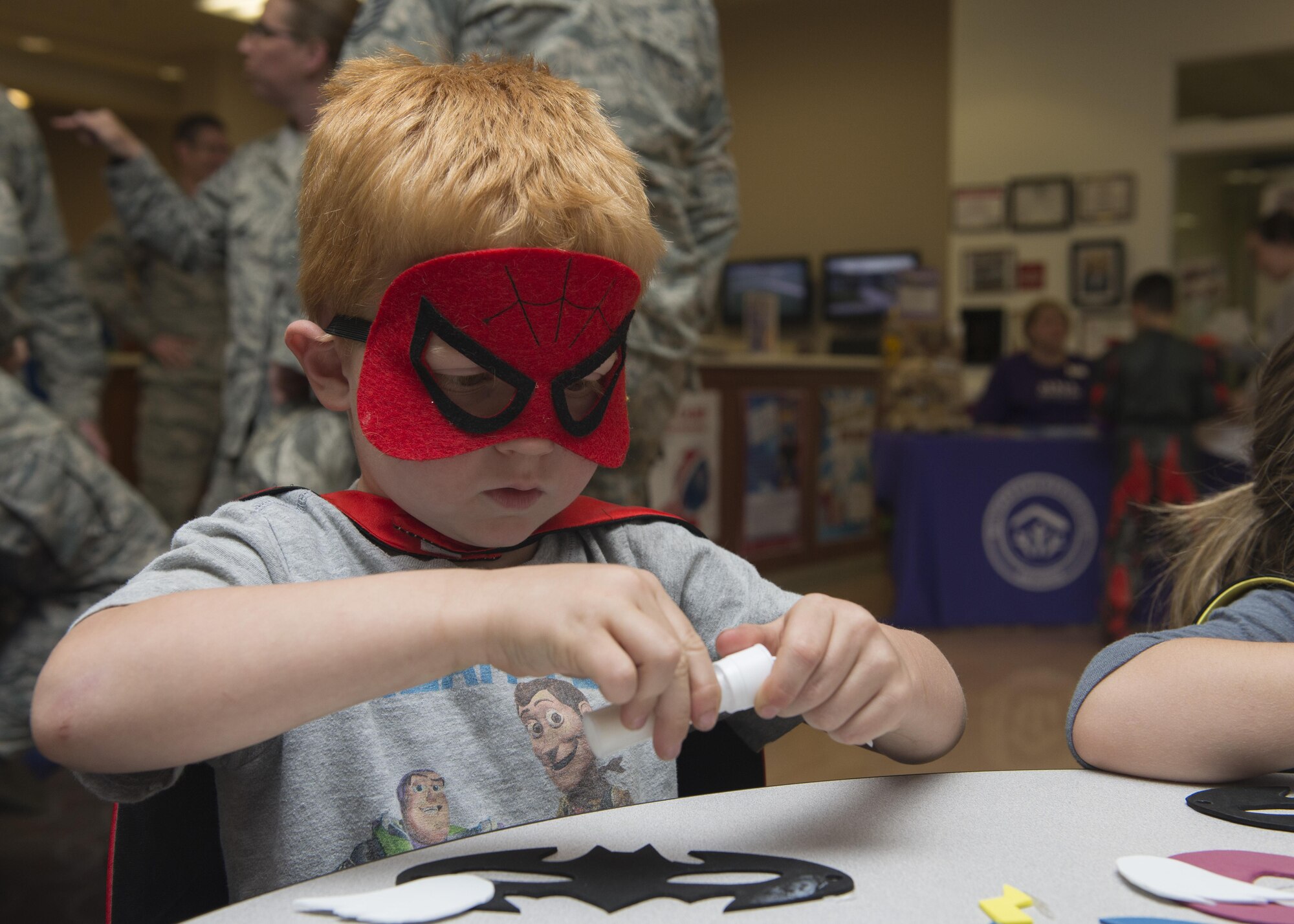 Shane Batts, son of Capt. Nate Batts, 3d Airlift Squadron pilot, creates a superhero facemask at a Deployed Families Dinner April 13, 2017, at the Youth Center on Dover Air Force Base, Del. Every dinner has a specific theme, with this one’s being “Superheroes.” (U.S. Air Force photo by Senior Airman Zachary Cacicia)