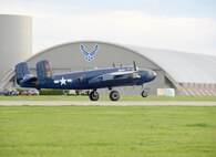 The B-25 Mitchell bomber Devil Dog lands on a runway next to the National Museum of the U.S. Air Force at Wright-Patterson Air Force Base, Ohio, April 17, 2017. The Devil Dog, out of Georgetown, Texas, is one of the 11 World War II bombers taking part in the museum’s celebration of the 75th anniversary of the Doolittle Raid when Army Air Corps bombers took off from an aircraft carrier to deliver the first strike of the war on the Japanese homeland. (U.S. Air Force photo by R.J. Oriez)