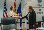 DLA Land and Maritime Commander Navy Rear Adm. Michelle Skubic (left) welcomes Roxanne Banks, deputy director of Acquisition (J7) for DLA, prior to an April 13 meeting at Defense Supply Center Columbus. Banks joined the Land and Maritime leadership team on a temporary rotational assignment to observe acquisition practices at an agency field level.