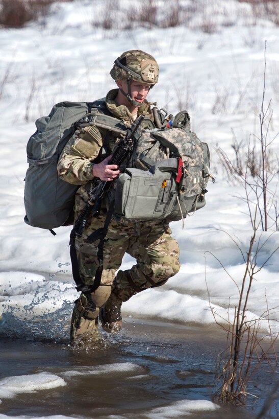 Army 1st Lt. Alexander Teynor proceeds to a rally point after airborne training at Joint Base Elmendorf-Richardson, Alaska, April 13, 2017. Teynor is assigned to the 25th Infantry Division’s Company A, 1st Battalion, 501st Parachute Infantry Regiment, 4th Infantry Brigade Combat Team (Airborne), Alaska. Air Force photo by Alejandro Pena