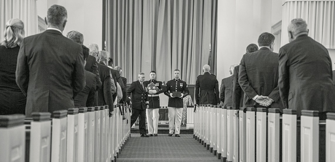 U.S. Marines with Marine Barracks Washington carry a flag and the remains of retired Lt. Gen. Lawrence F. Snowden.