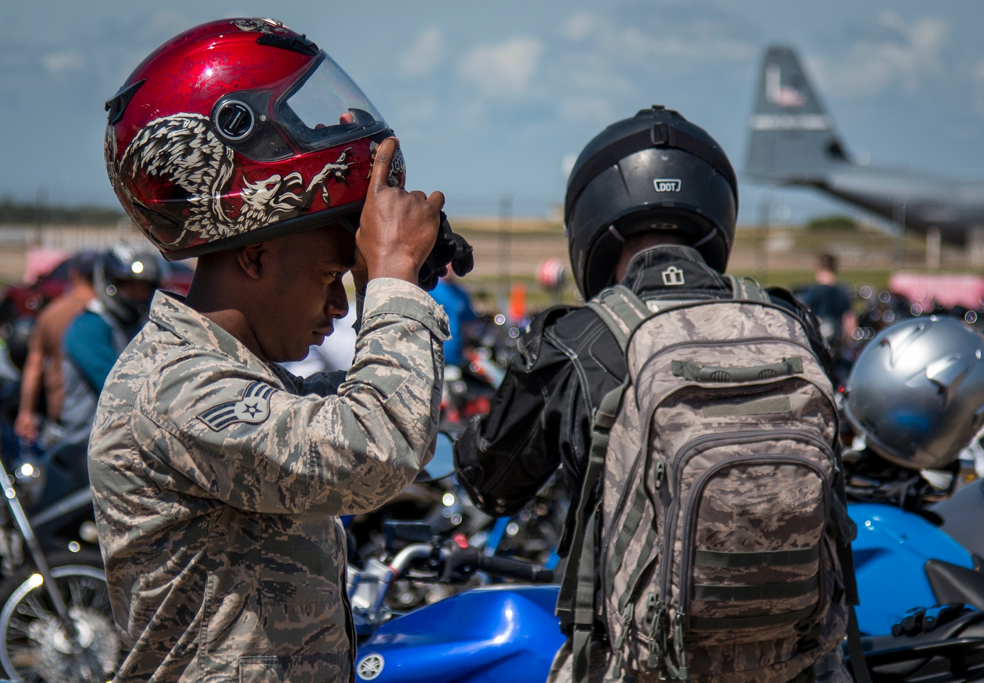A senior airman puts on his helmet after the annual motorcycle safety rally at Eglin Air Force Base, Fla., April 14.  More than 500 motorcyclists came out for the event that meets the annual safety briefing requirement for base riders.  (U.S. Air Force photo/Samuel King Jr.)