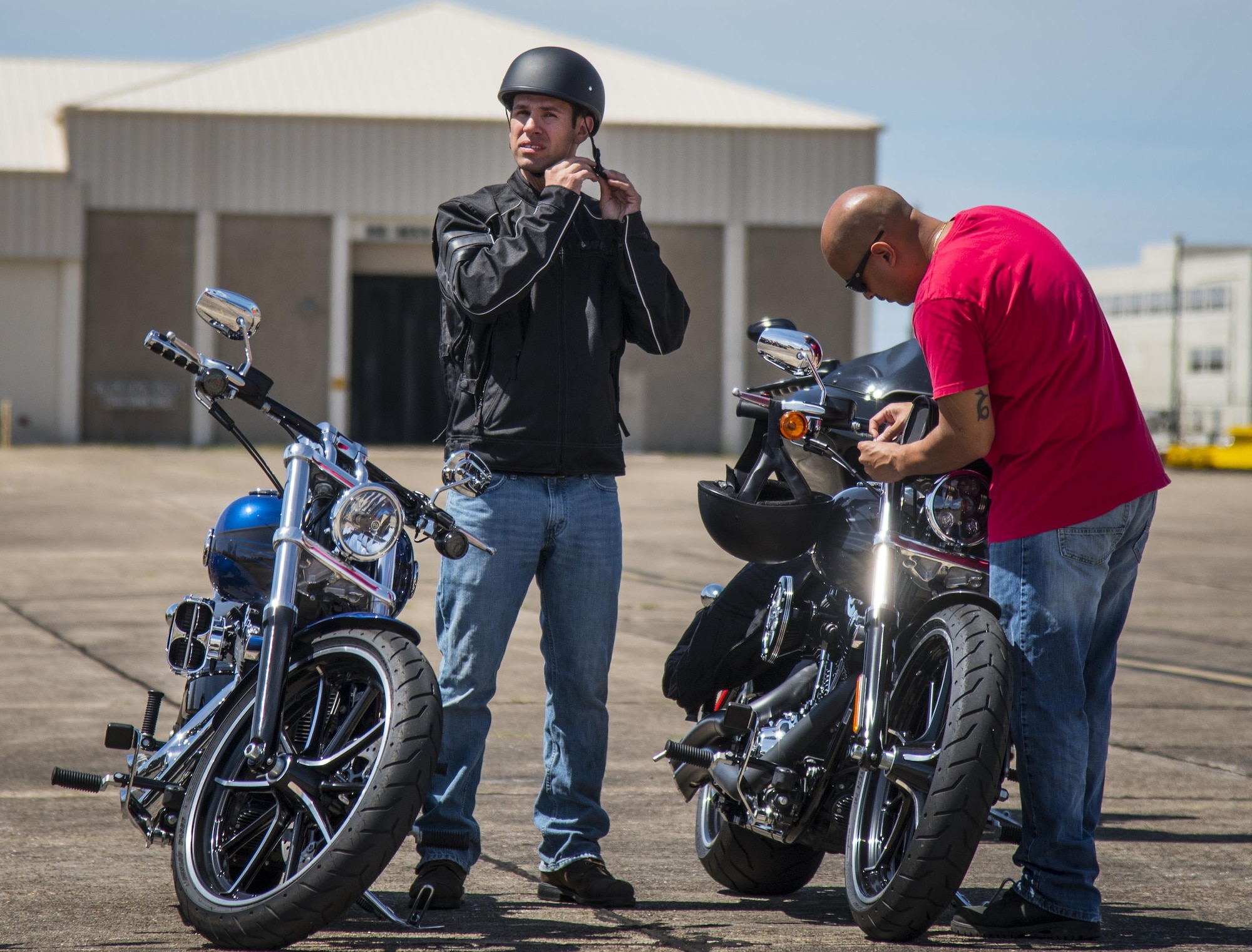 An Airman puts on his helmet after the annual motorcycle safety rally at Eglin Air Force Base, Fla., April 14.  More than 500 motorcyclists came out for the event that meets the annual safety briefing requirement for base riders.  (U.S. Air Force photo/Samuel King Jr.)