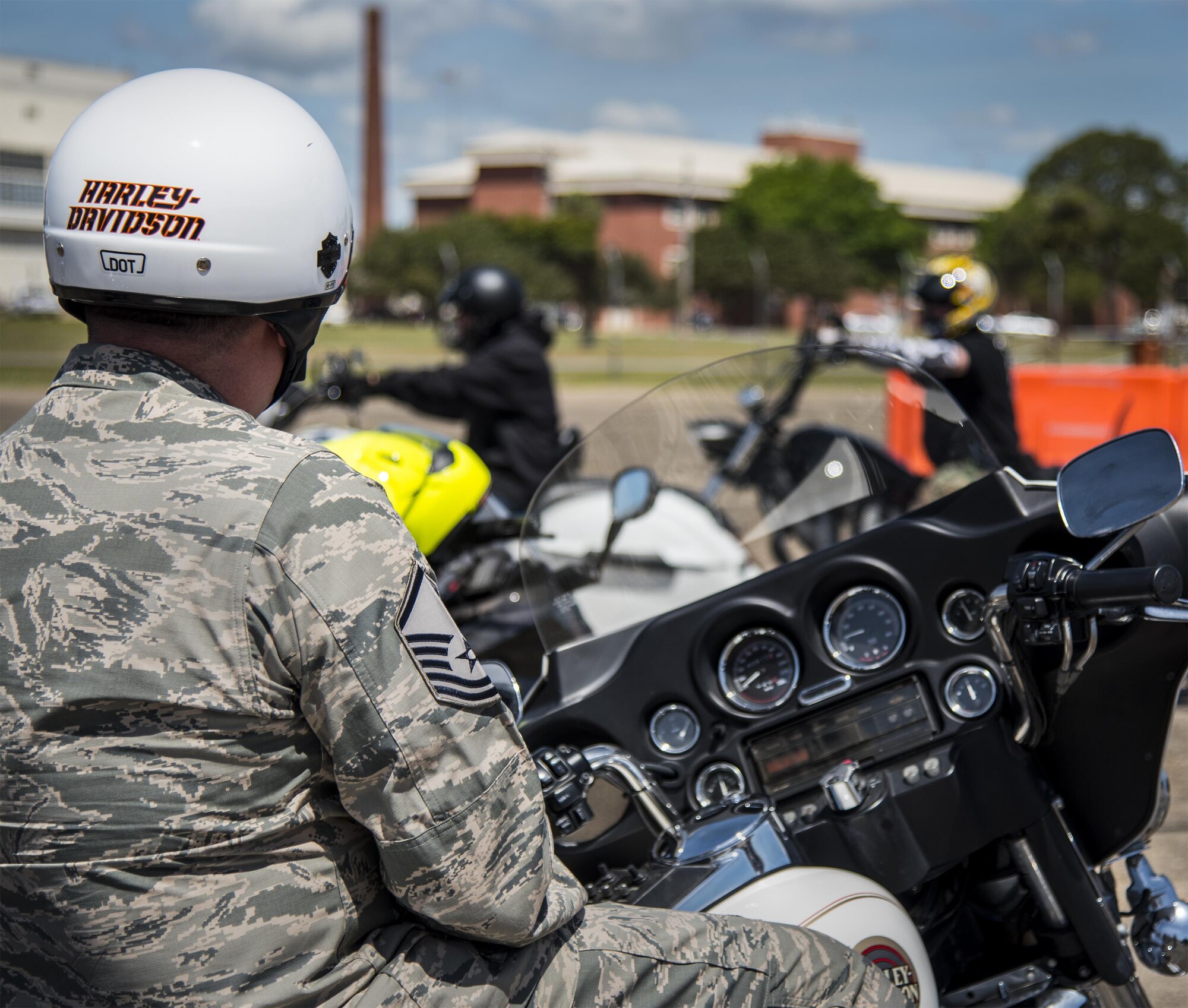 A master sergeant watches as bikers roll out after the annual motorcycle safety rally at Eglin Air Force Base, Fla., April 14.  More than 500 motorcyclists came out for the event that meets the annual safety briefing requirement for base riders.  (U.S. Air Force photo/Samuel King Jr.)